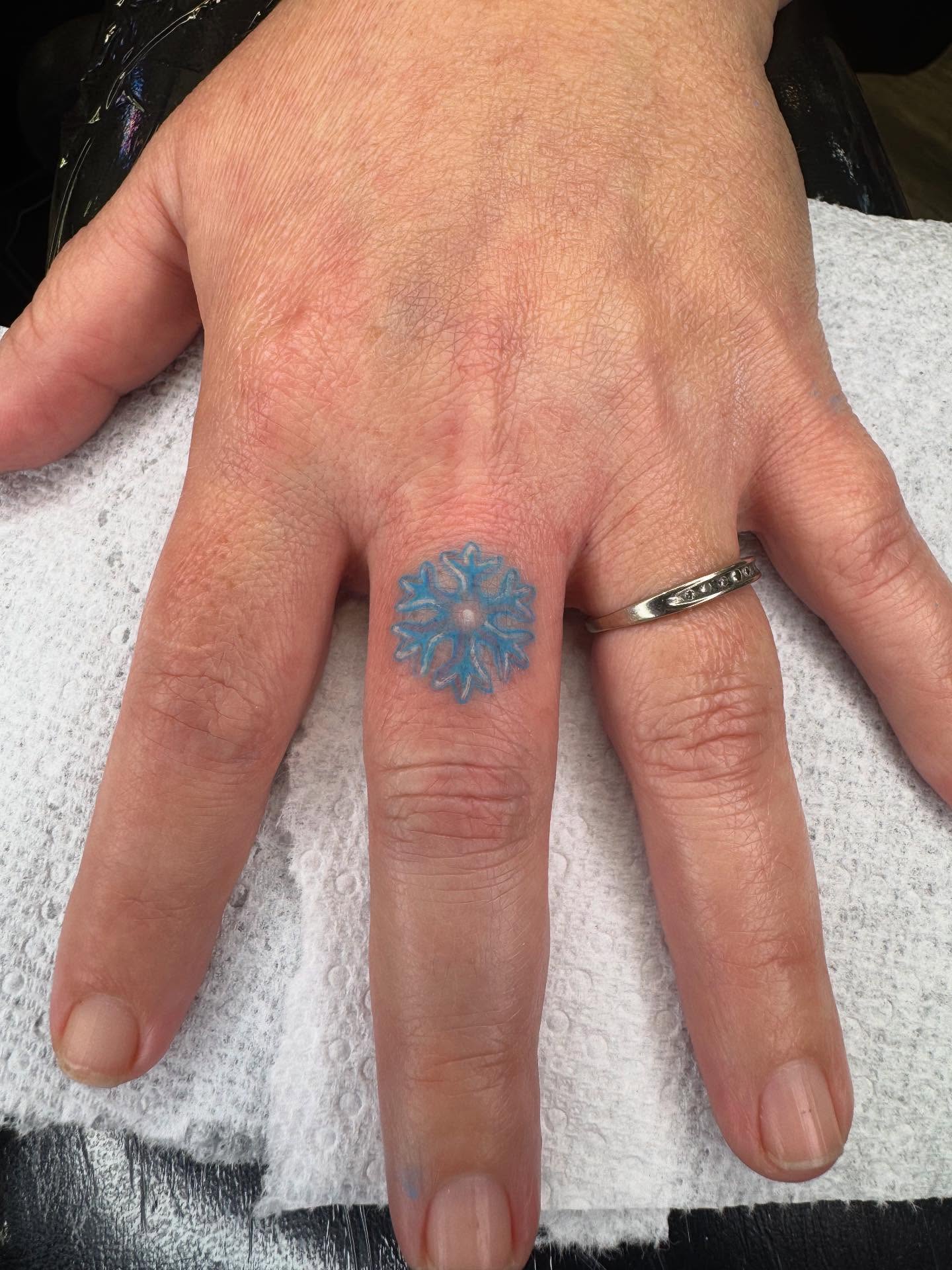 Snowflake geometric tattoo on the hand by Brandon Heredia, Vacaville, California