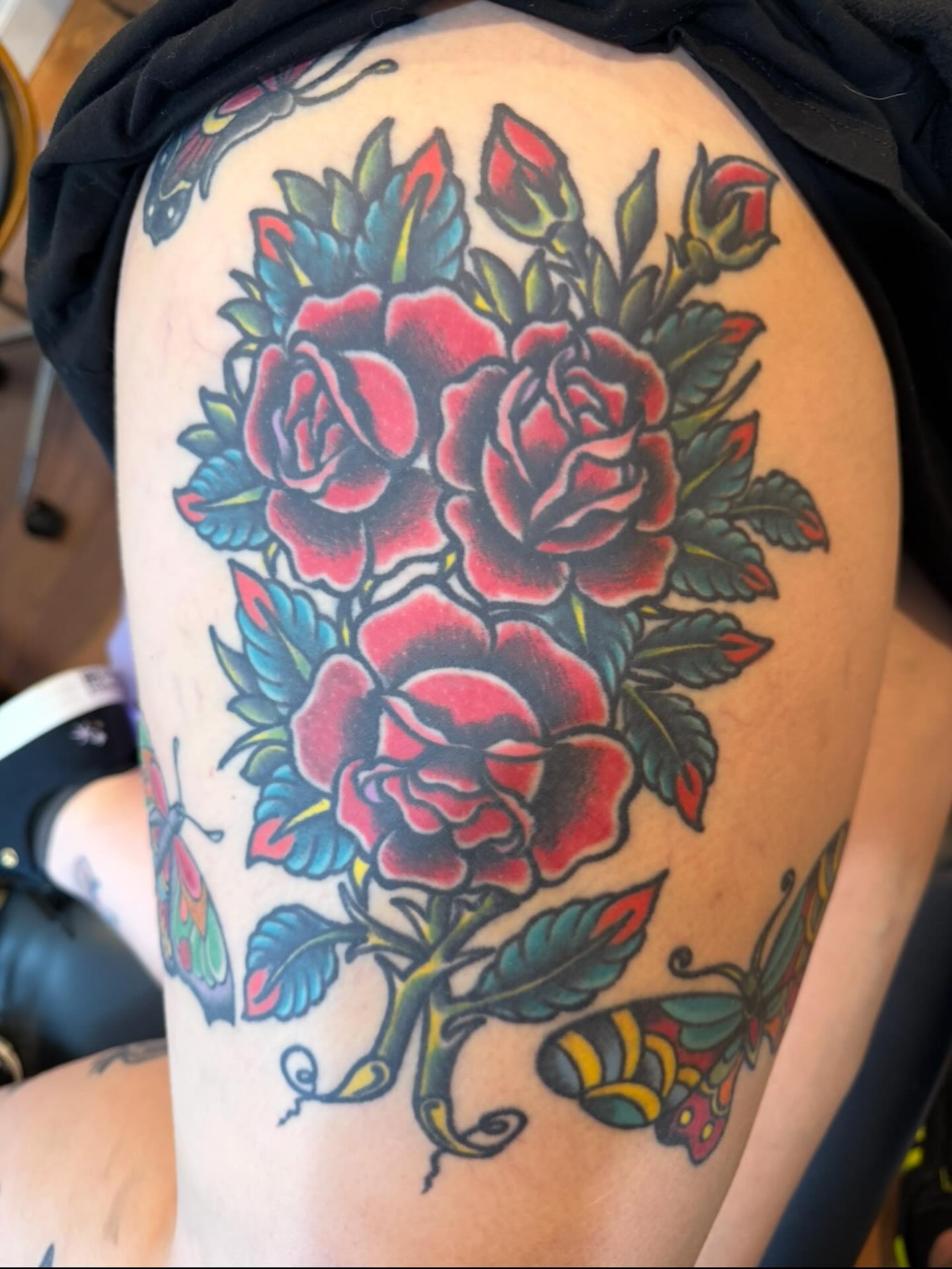Roses American traditional tattoo on the thigh by Mike Kepper
