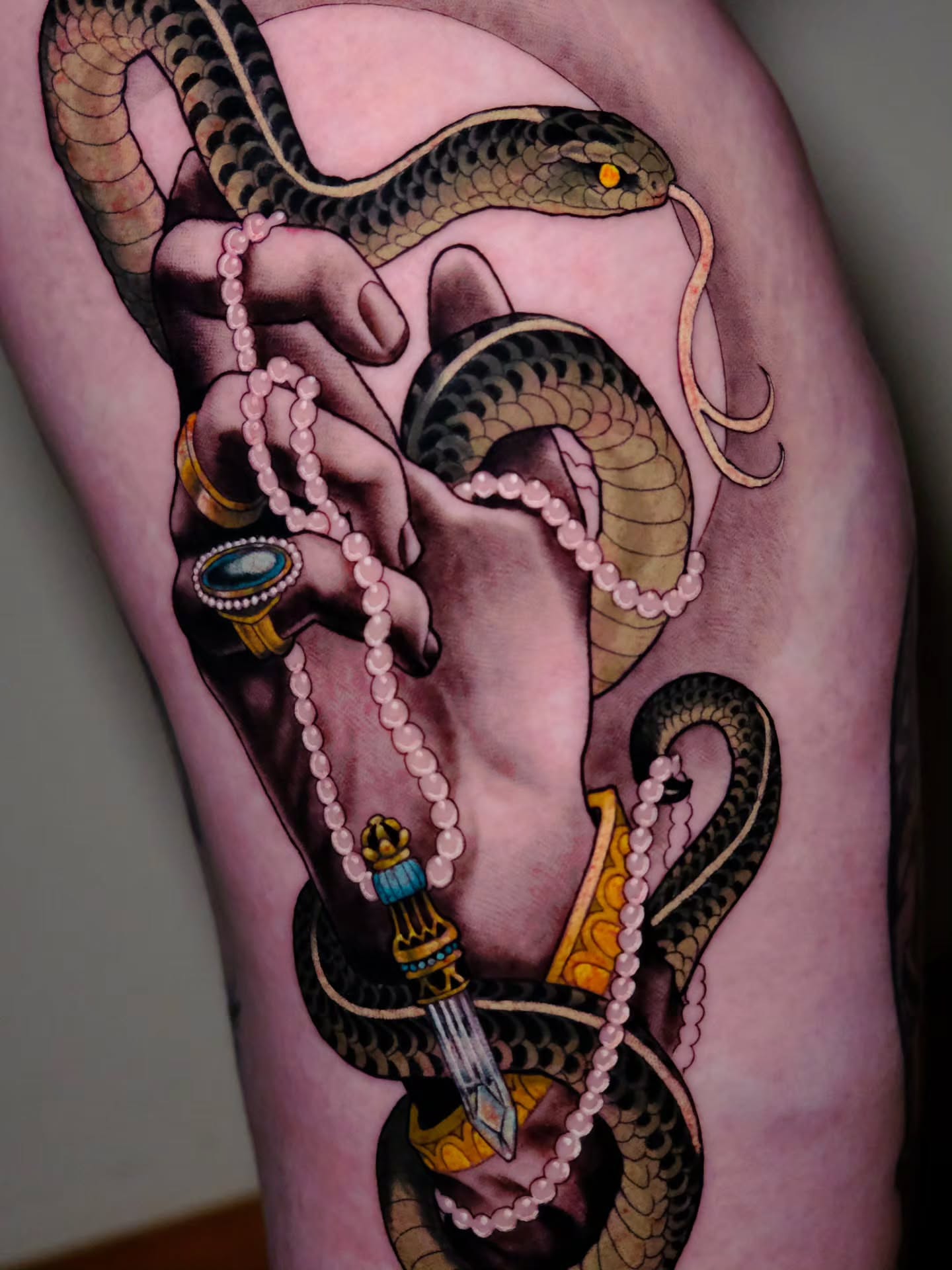 Snake and pearl necklace American traditional tattoo on the thigh by Tash  - Seattle Tattoo Artist