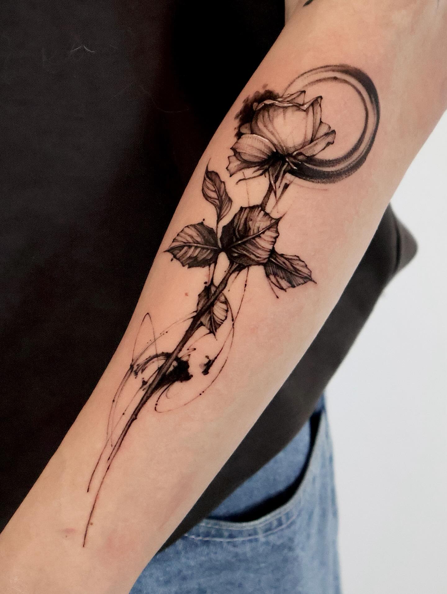 Flower and crescent moon realism tattoo on the forearm by Tadi