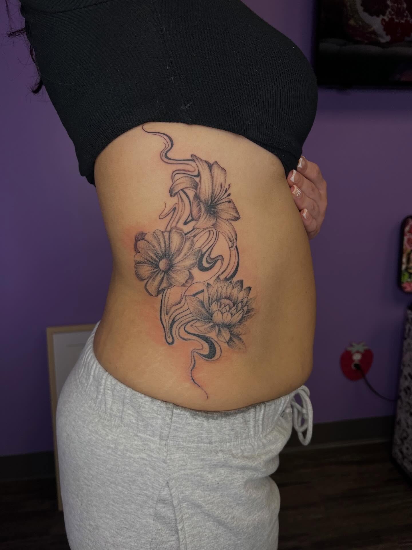 Flowers black and grey tattoo on the ribs by Ebony Robinson, Austintown, Ohio