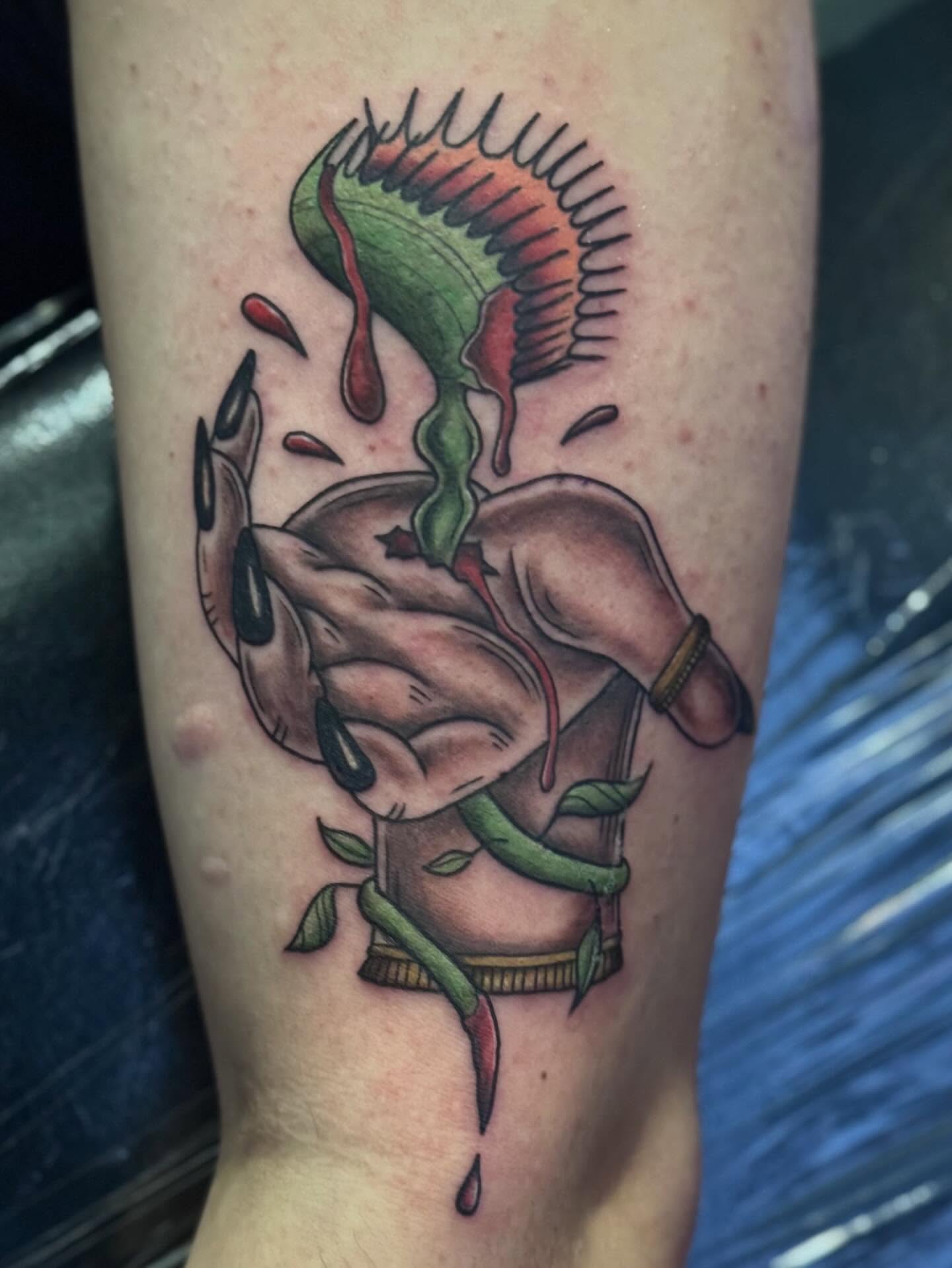 Hand holding chili peppers realism tattoo on the forearm by @carissaetattoos