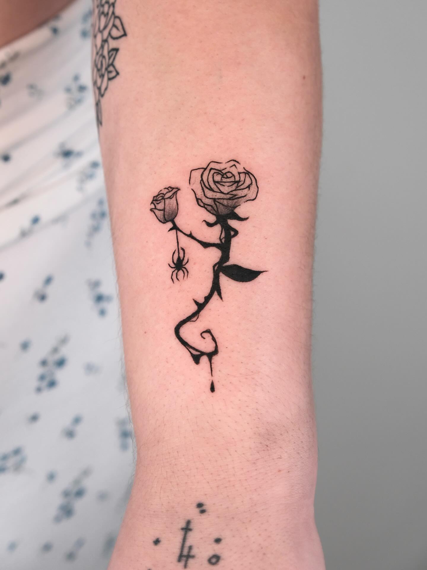 Rose with spider black and grey tattoo on the forearm by Elana Hites