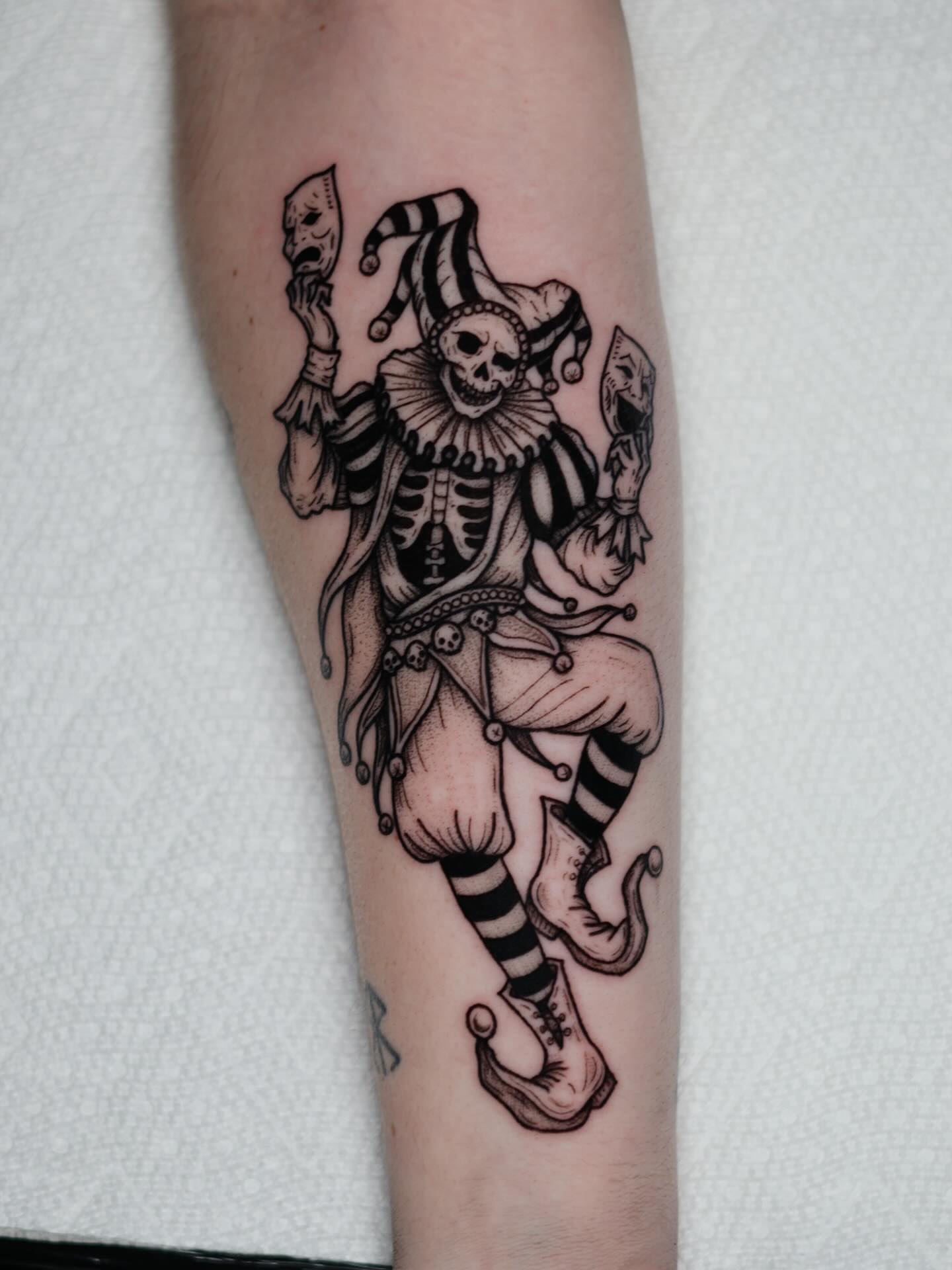 Clown skeleton black and grey tattoo on the forearm by Koko