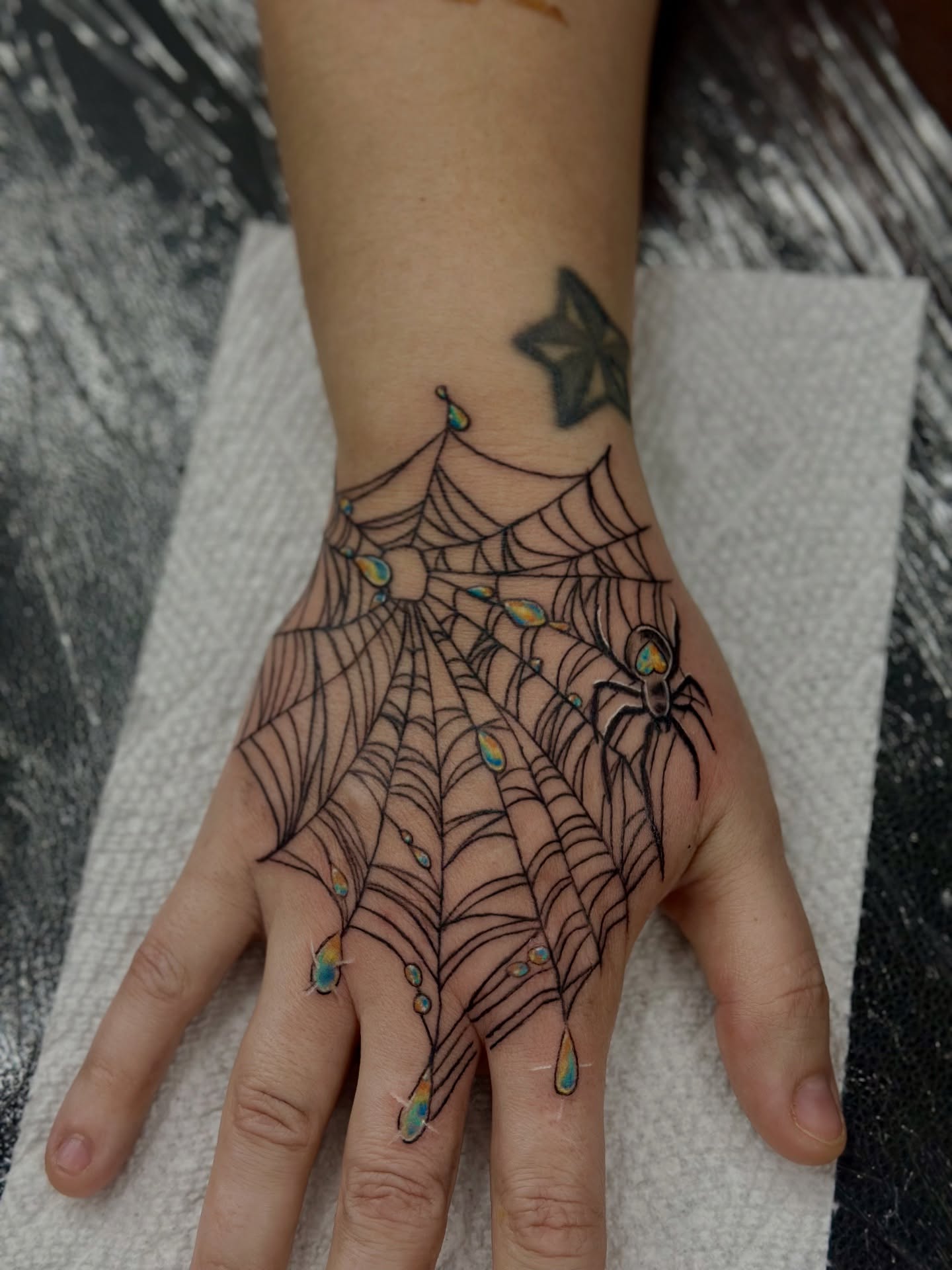 Spider web geometric tattoo on the hand by Sk Pierce