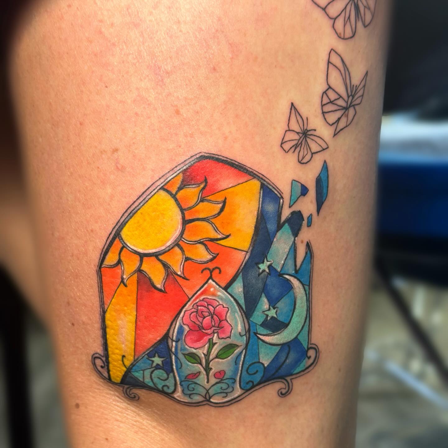 Sun, moon, rose, butterflies geometric tattoo on the thigh by Elly Bordwell