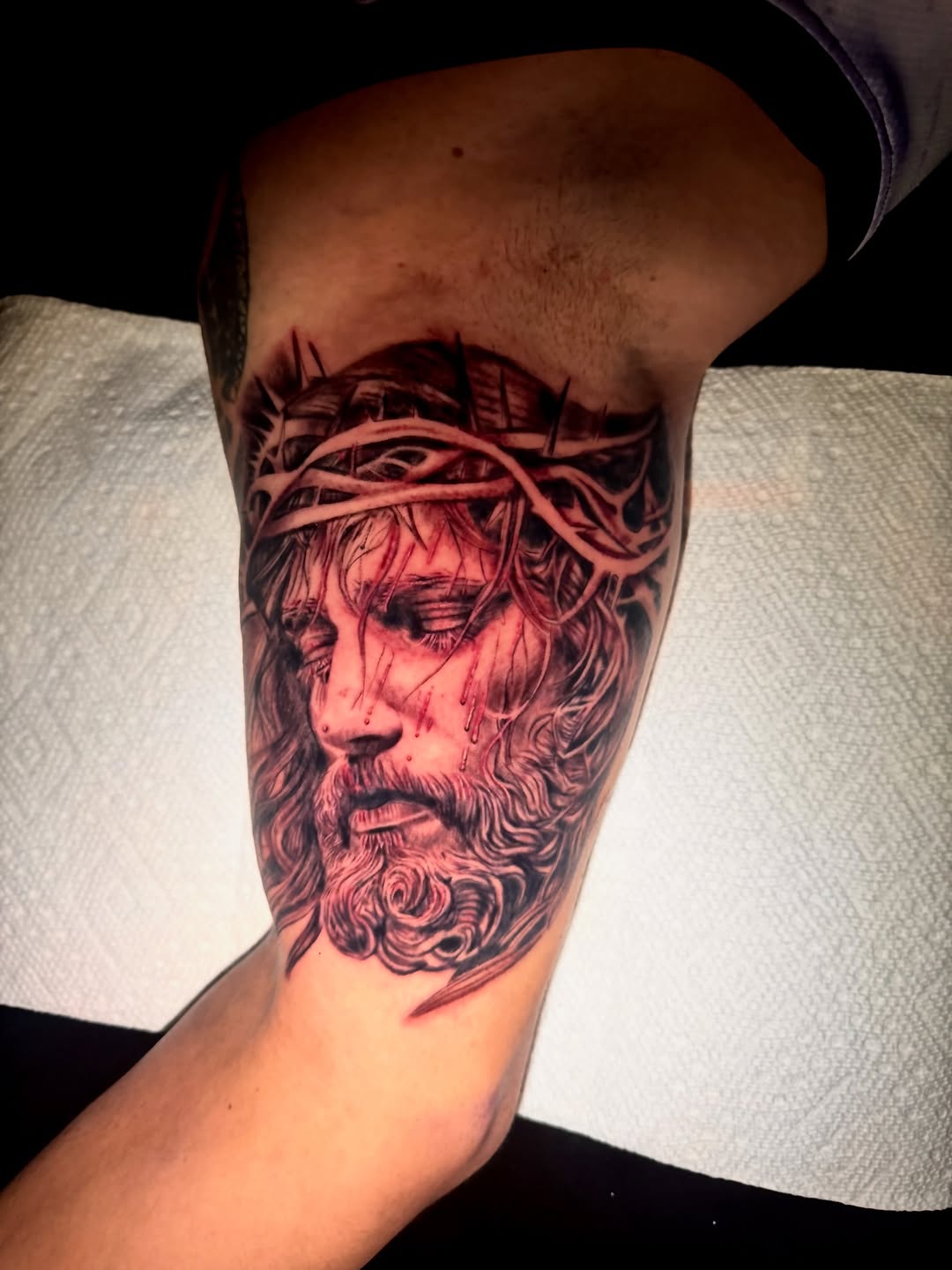 Jesus Christ with crown of thorns realism tattoo on the forearm by Tampa tattoo artist