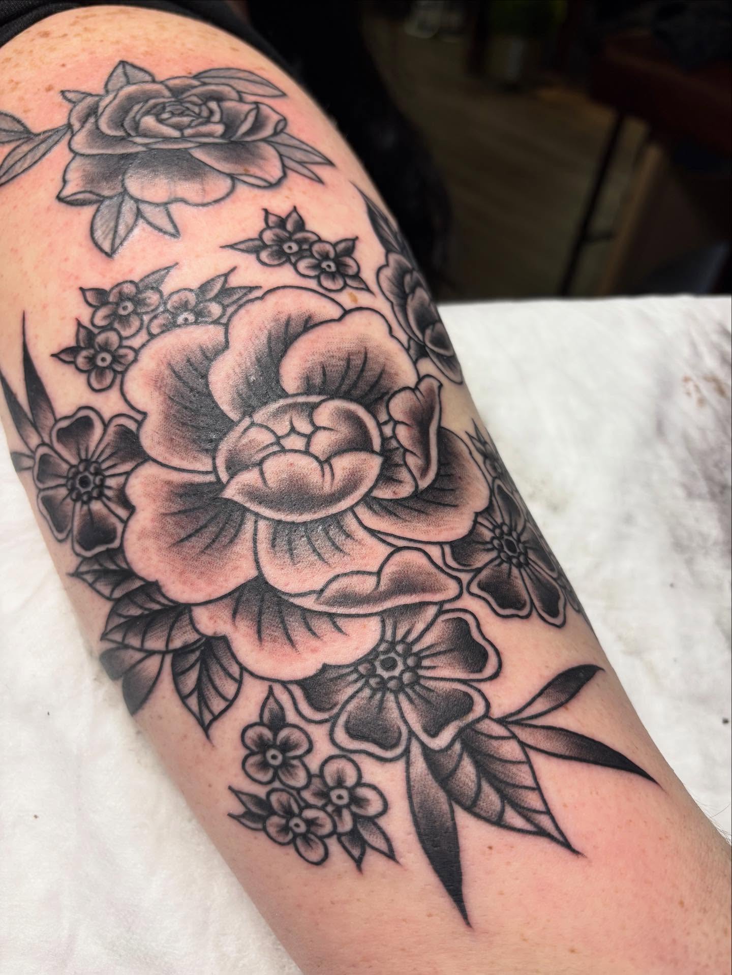 Floral bouquet black and grey tattoo on the forearm by gia❤️‍🔥🎲, Maryville, Tennessee