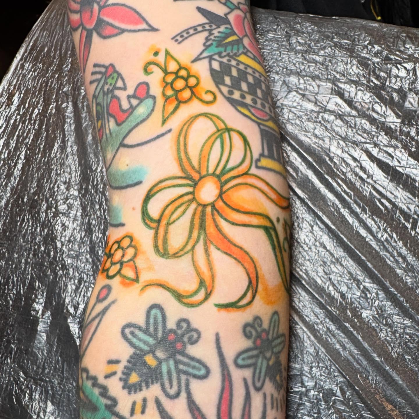 Floral arrangement American traditional tattoo on the forearm by JoJo Benton