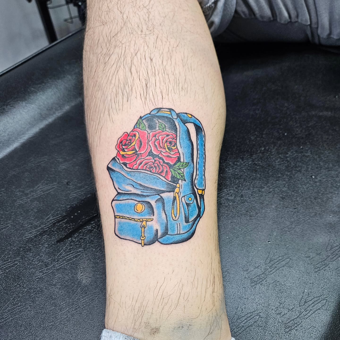 Backpack with roses new school tattoo on the calf by Danny