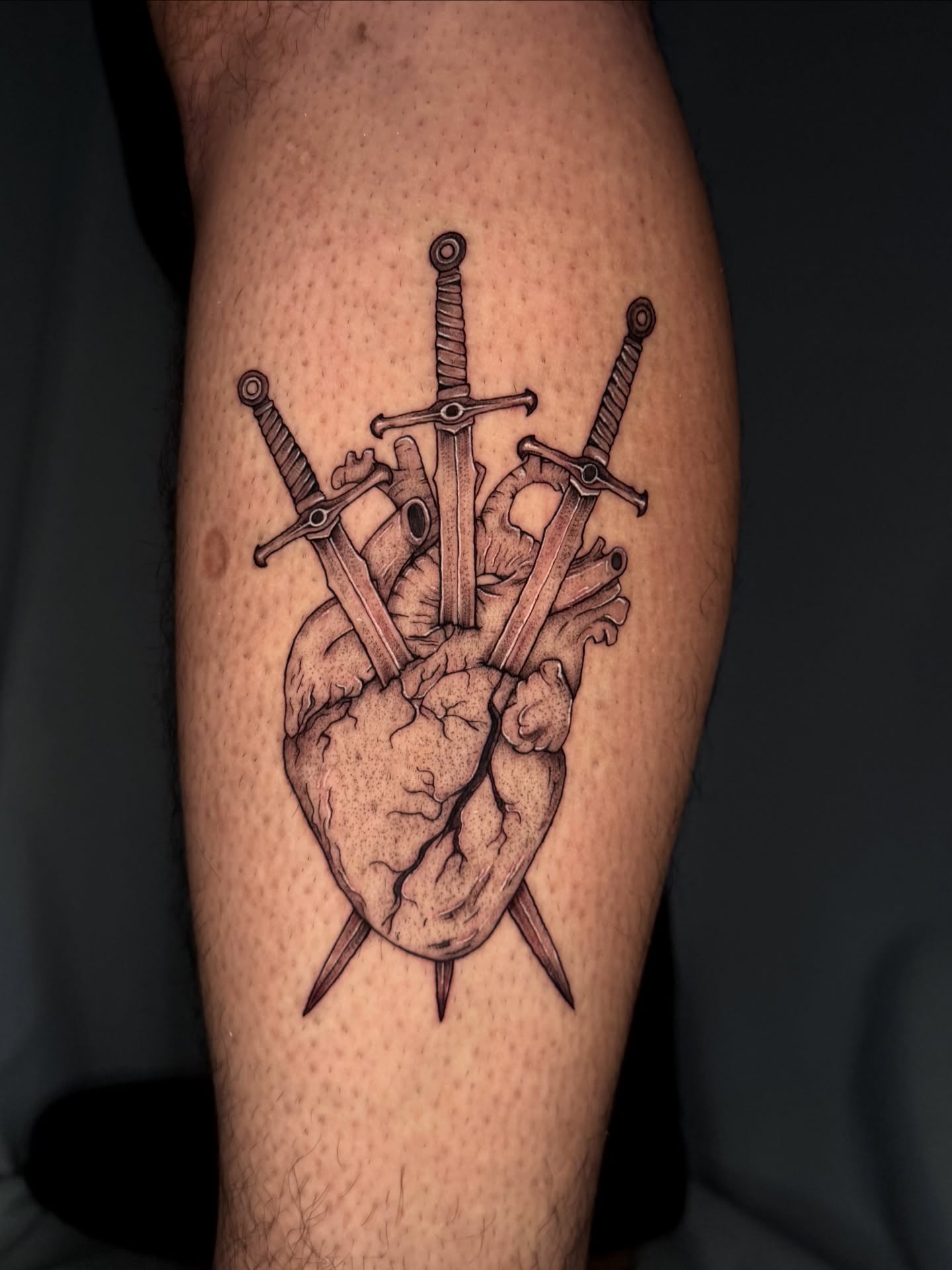 Heart with swords realism tattoo on the thigh by Gillian Norland, Las Vegas, Nevada