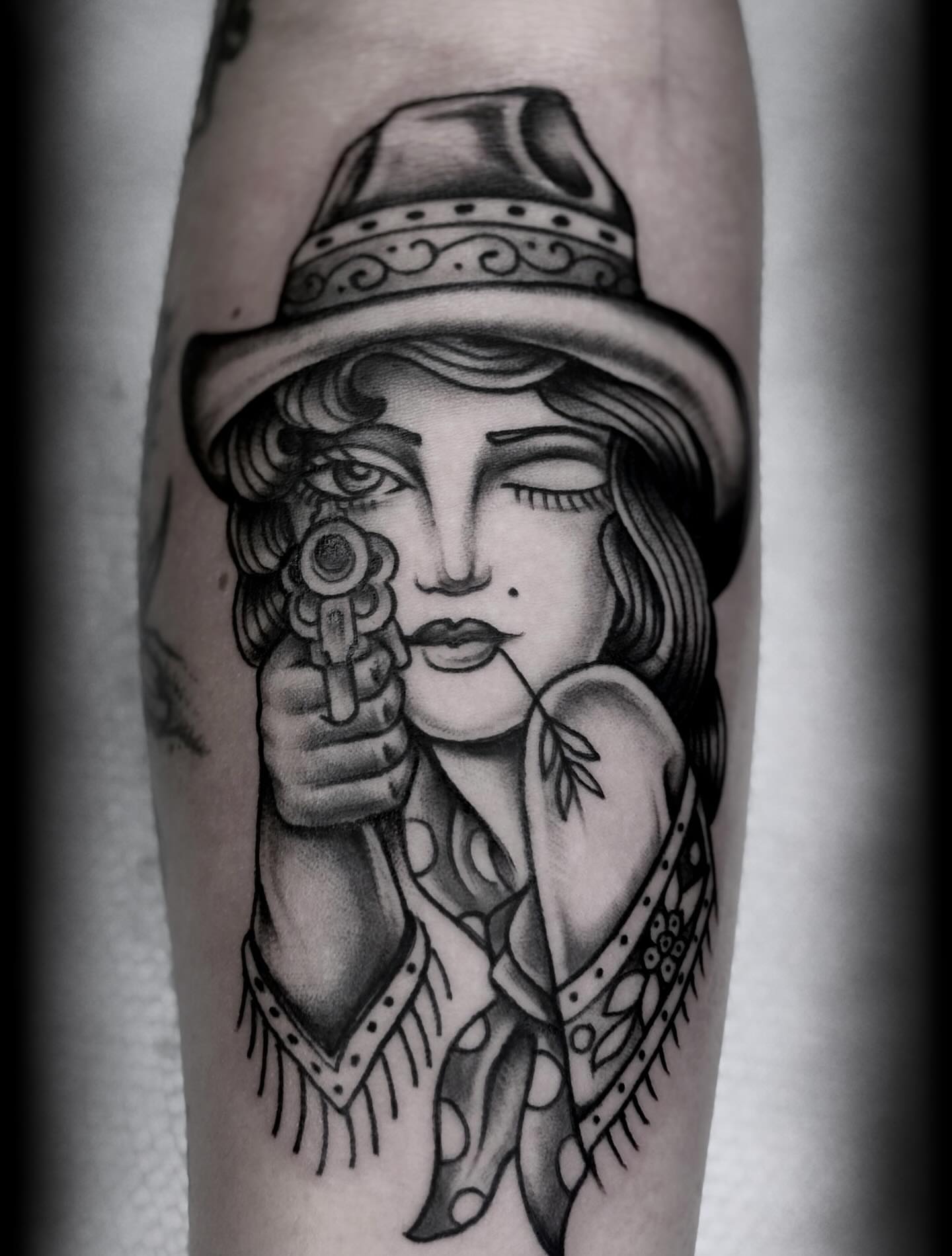 Cowgirl with gun American traditional tattoo on the forearm by “𝙺𝚊𝚒𝚗 𝚅𝚎𝚕𝚊𝚜𝚌𝚘”, Austin, Texas