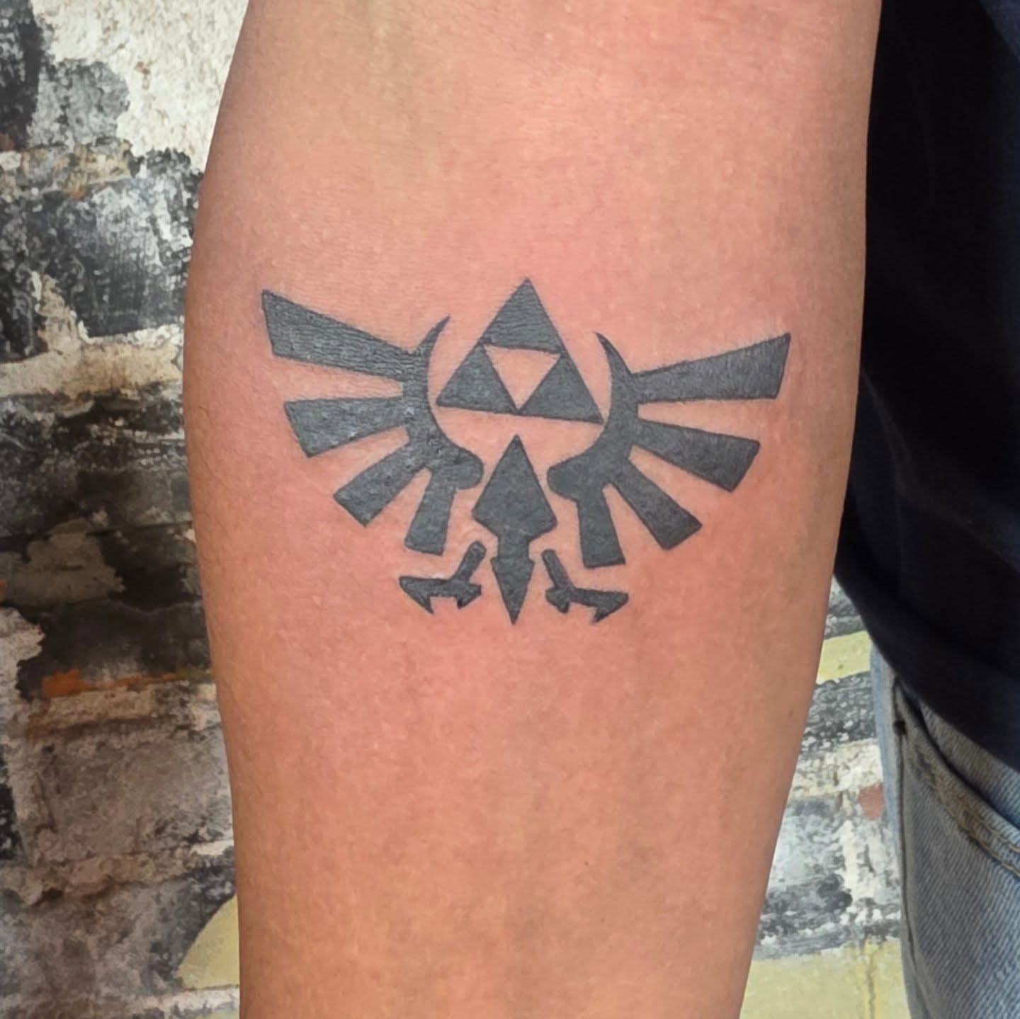Triforce geometric tattoo on the forearm by Tattoos by Annie