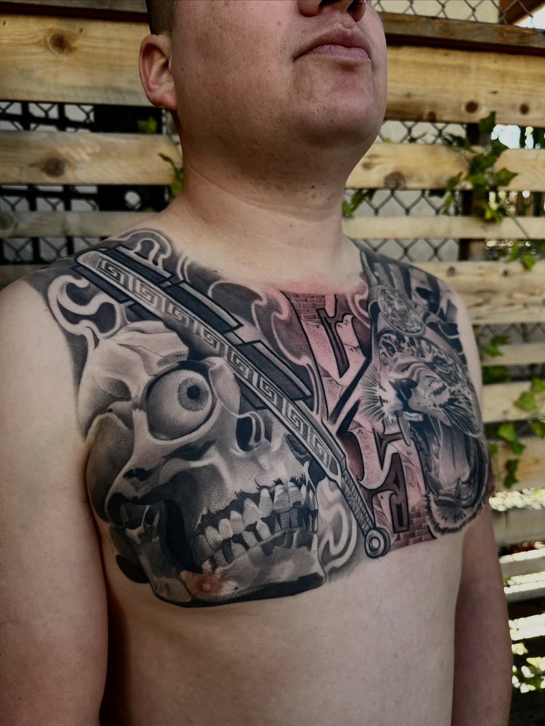 Skull, tiger, and sword realism tattoo on the chest by San Diego Tattoo Artist