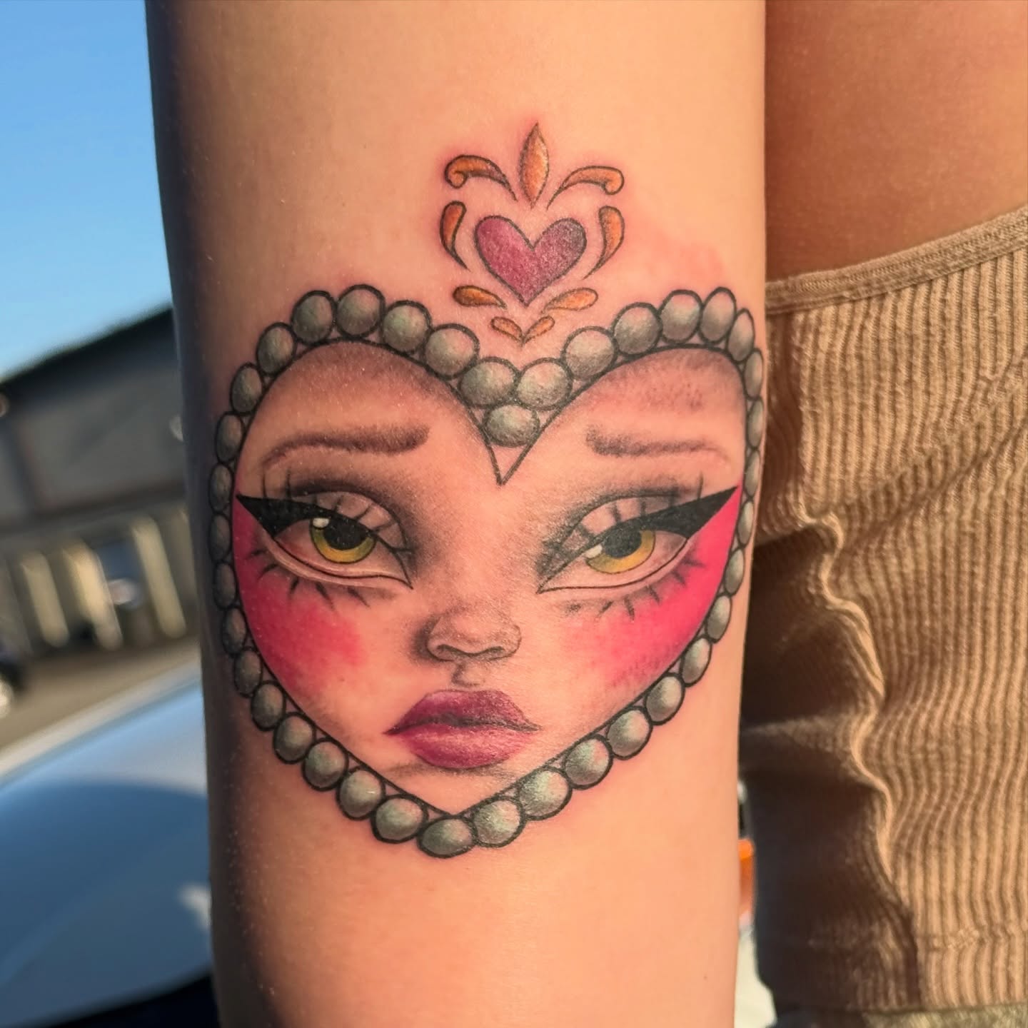 Heart-shaped face realism tattoo on the forearm by Whimsical illustrative