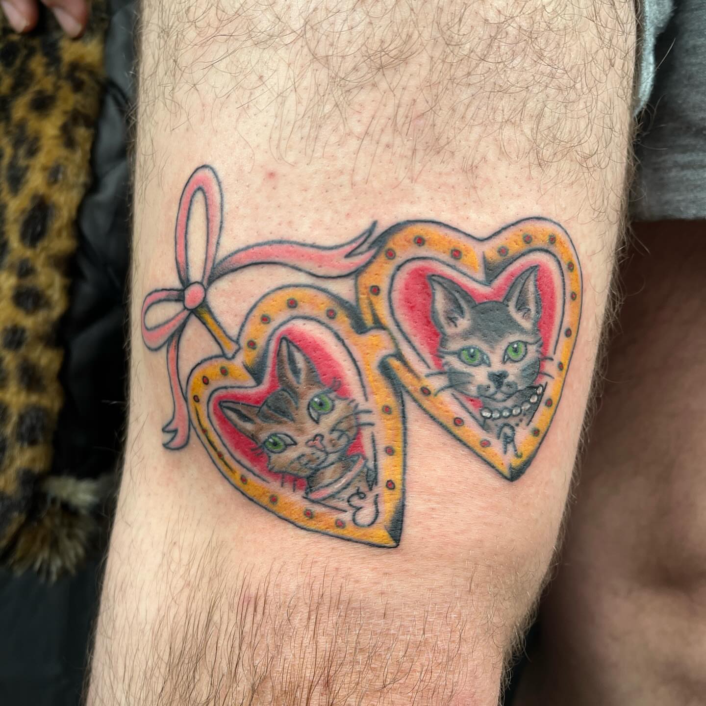 Cats in hearts American traditional tattoo on the forearm by sarah