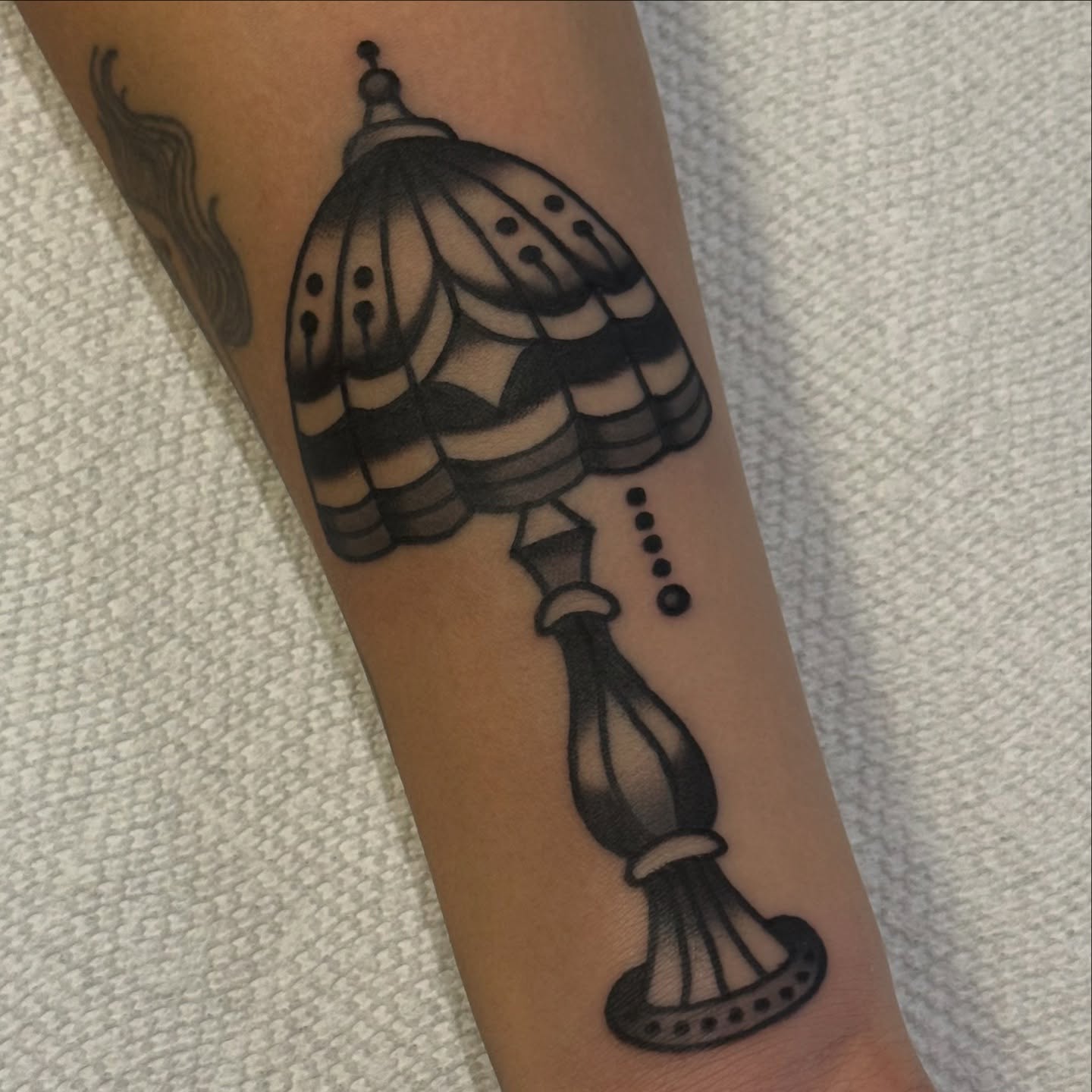Lampshade dotwork tattoo on the forearm by Erin Chambers