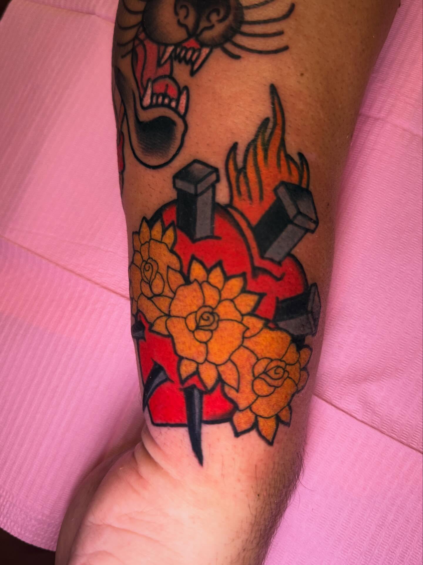 Heart with roses American traditional tattoo on the forearm by Cassie O'Neal DeBord