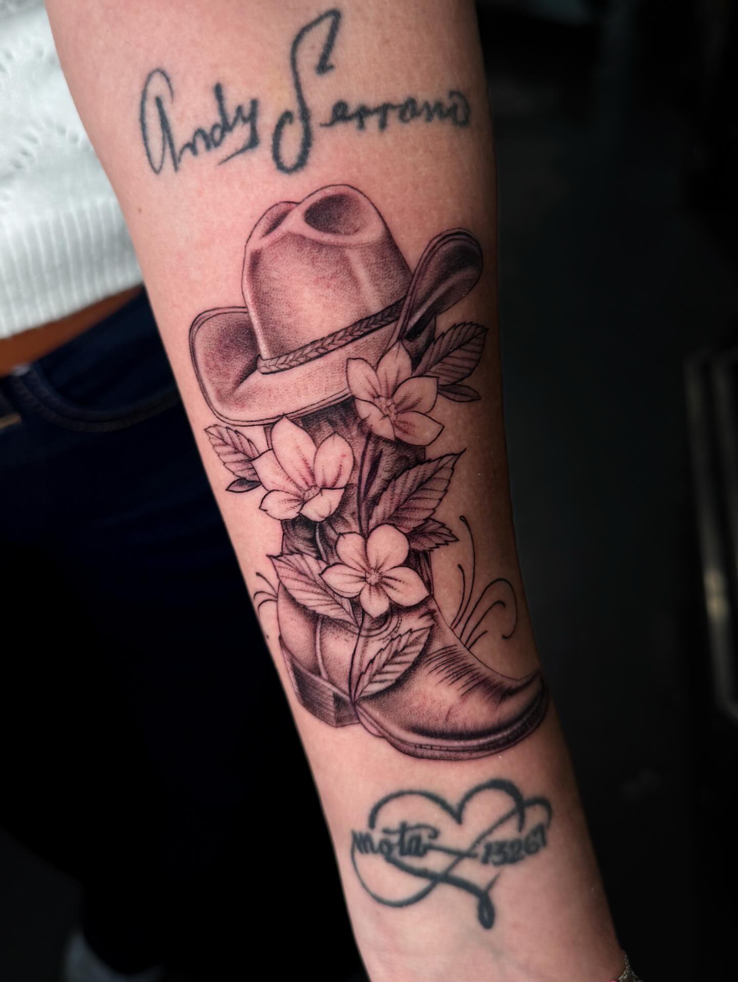 Cowboy boot and hat realism tattoo on the forearm by Demi DiMartino