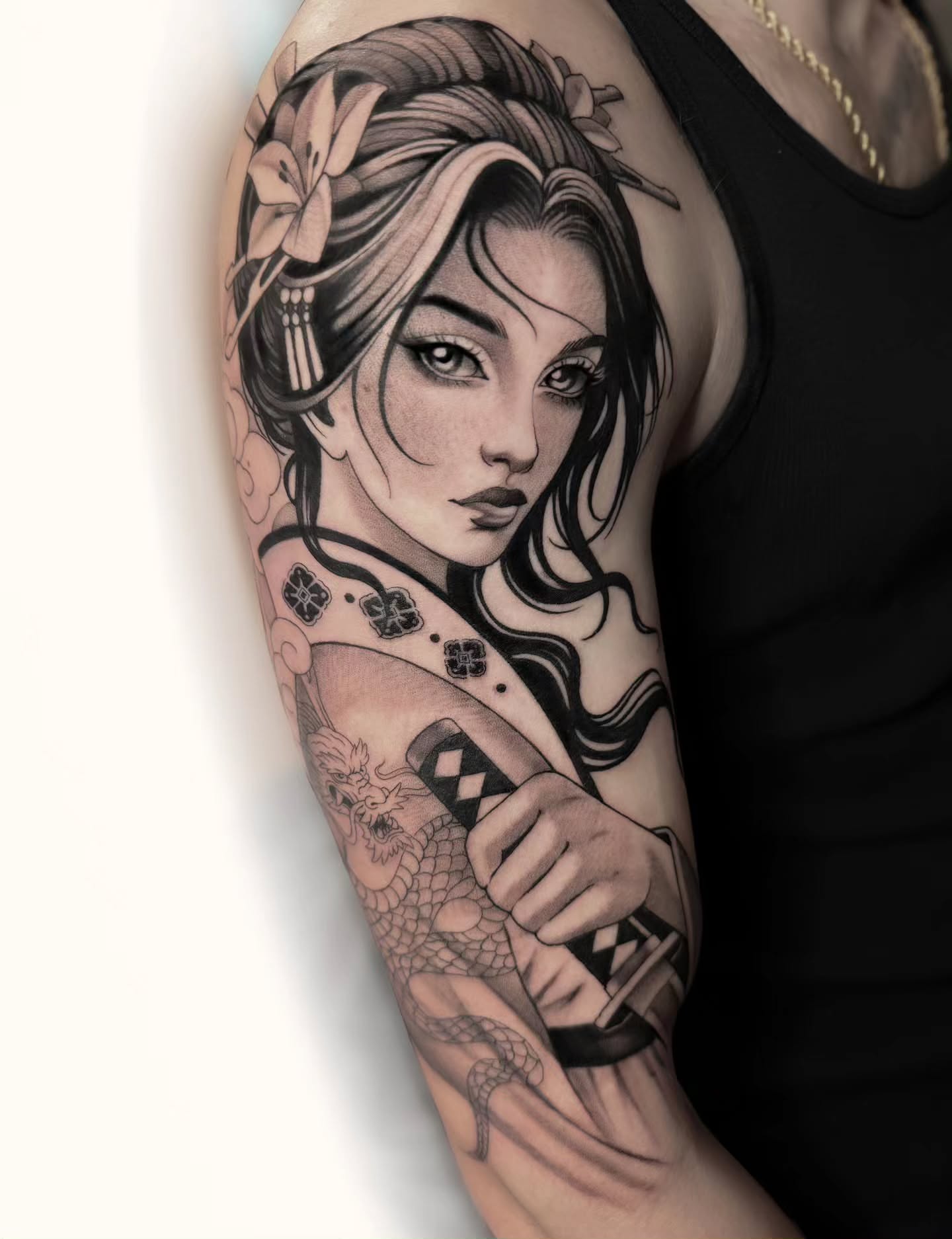 Geisha realism tattoo on the upper arm by Kelsi Steffensen