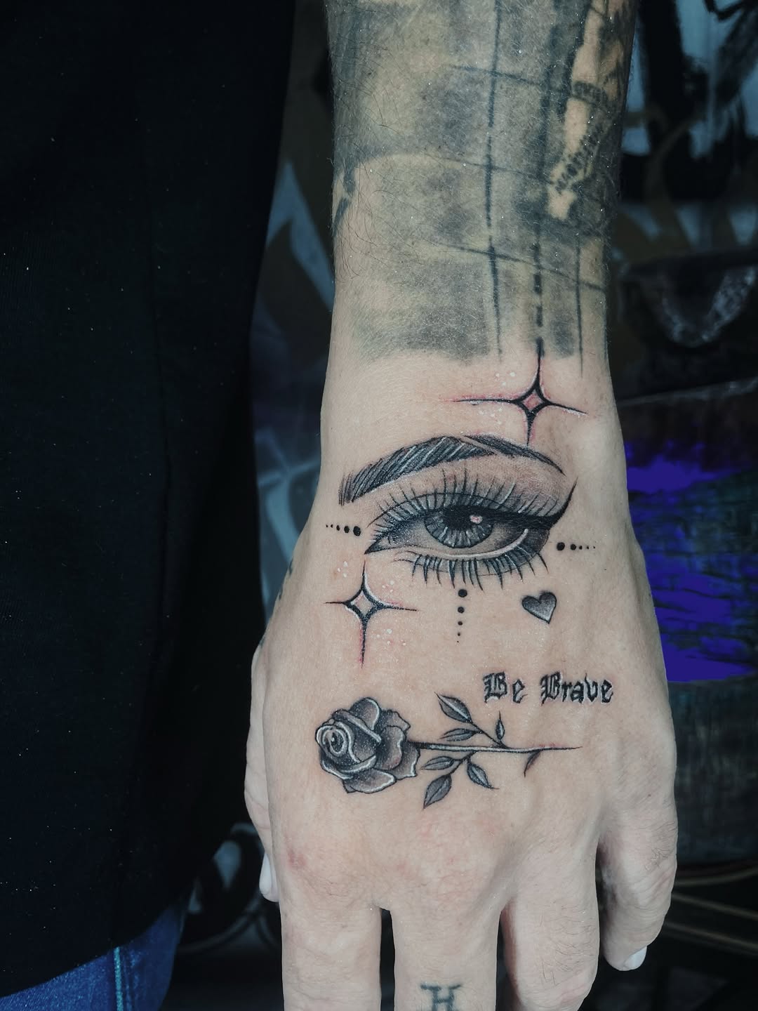 Eye and rose with script dotwork tattoo on the hand by Alvaro