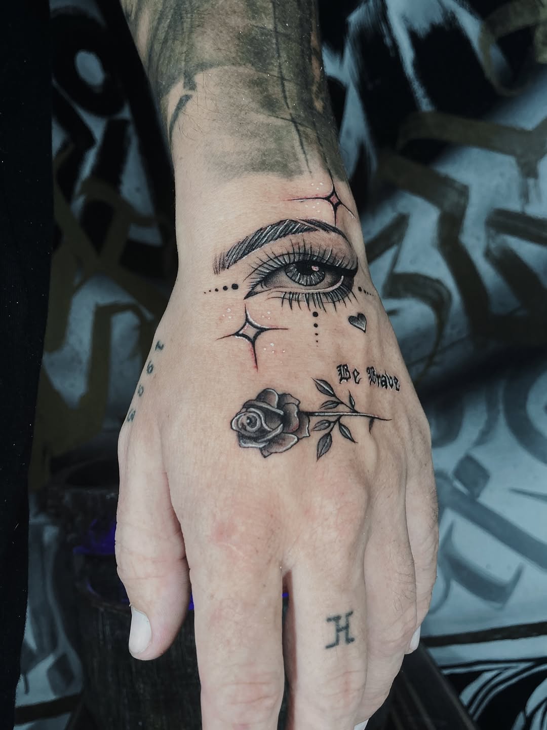 Eye and rose with script surrealism tattoo on the hand by Alvaro