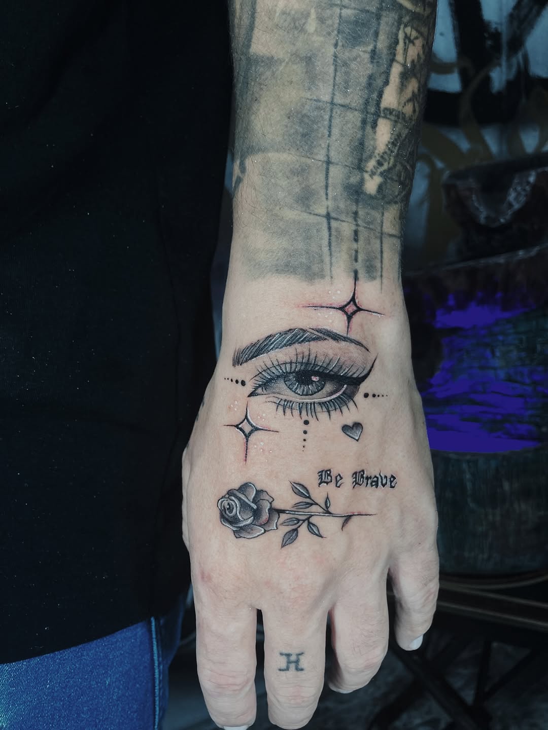 Eye and rose with script dotwork tattoo on the hand by Alvaro