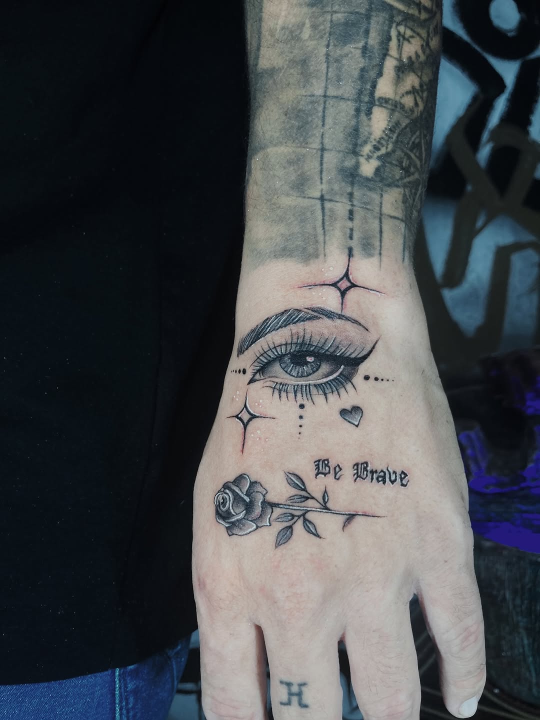 Eye and rose with script dotwork tattoo on the hand by Alvaro