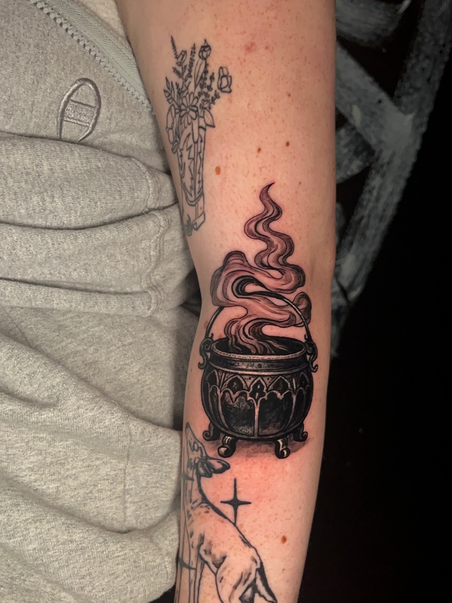 Cauldron with steam black and grey tattoo on the forearm by Ryan Hindenach
