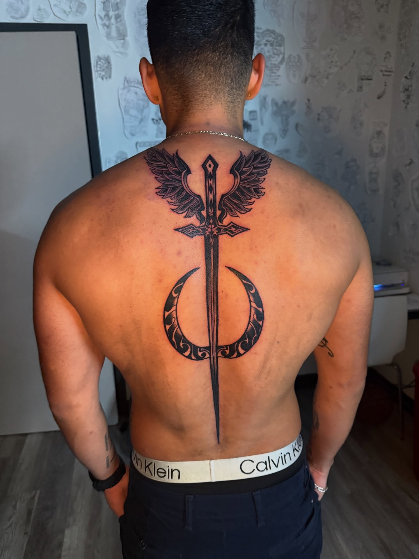 Sword and phoenix black and grey tattoo on the back by Atlanta Tattoo Artist