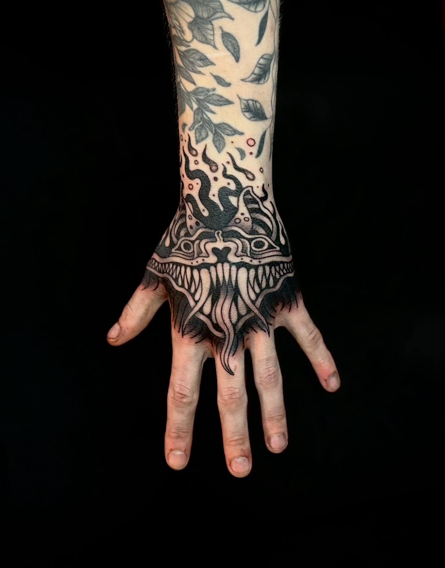 Monster dark realism tattoo on the hand by Ashley Kayser