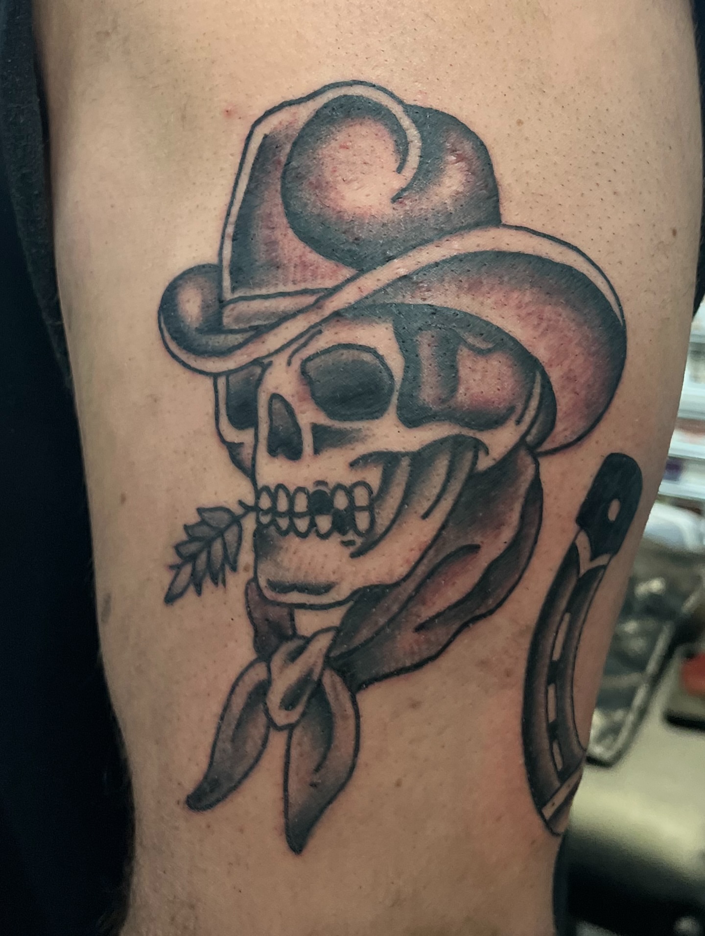 Cowboy skull black and grey tattoo on the forearm by Ashley Camp