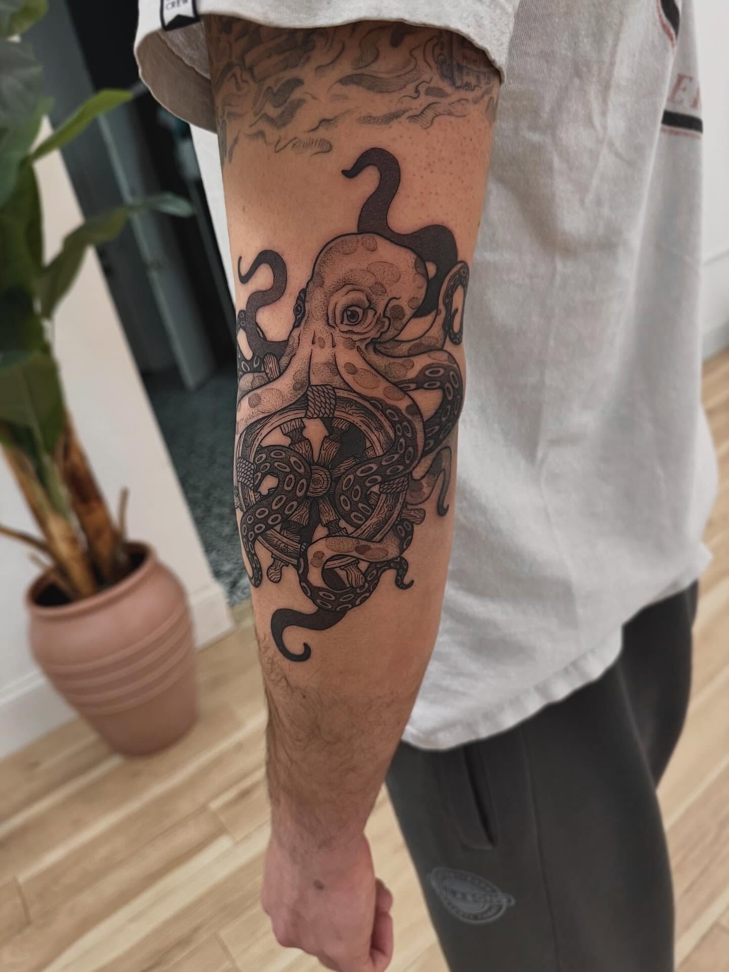 Octopus black and grey tattoo on the forearm by Stefany
