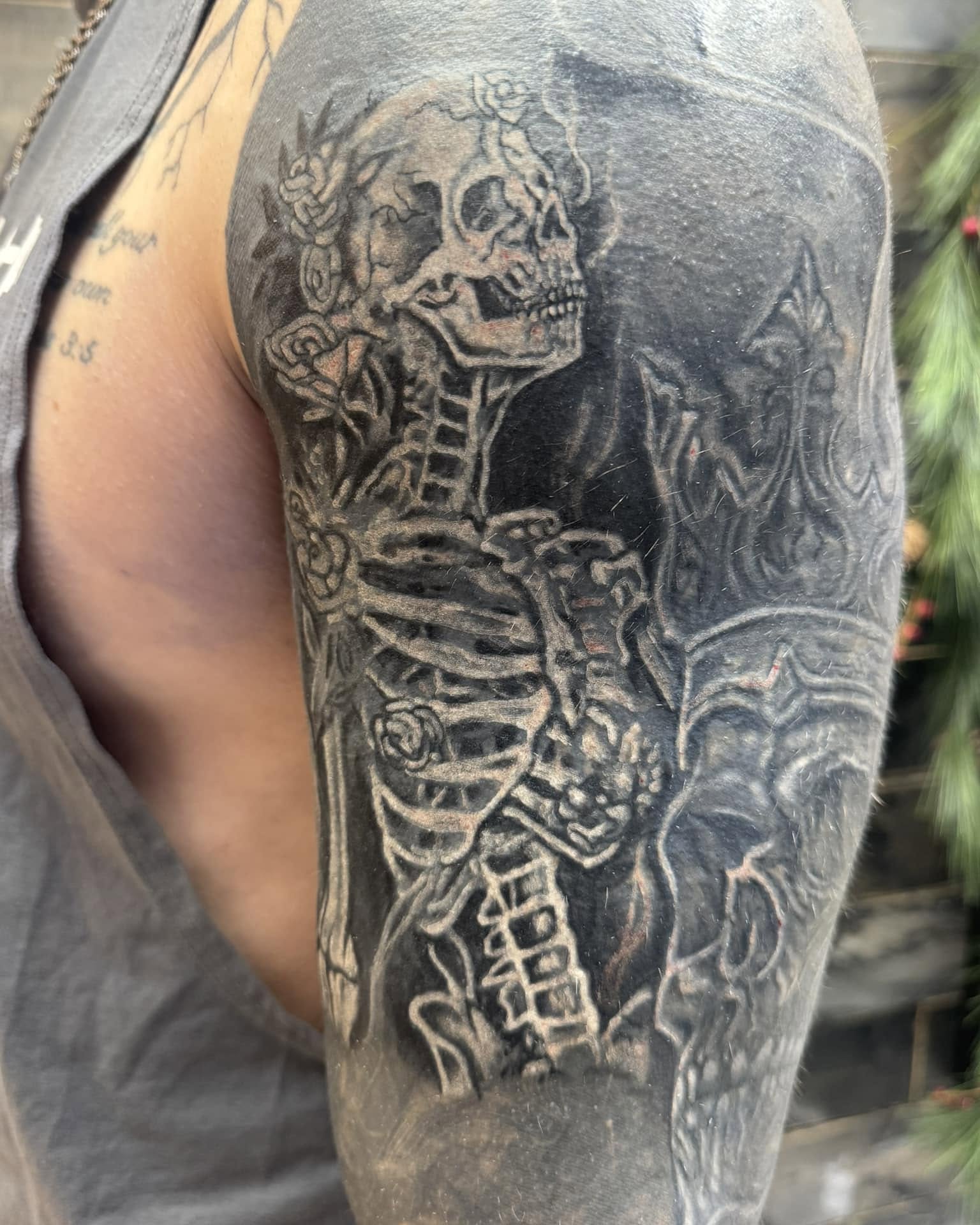 Skeleton with roses realism tattoo on the shoulder by Chris Allen Taylor