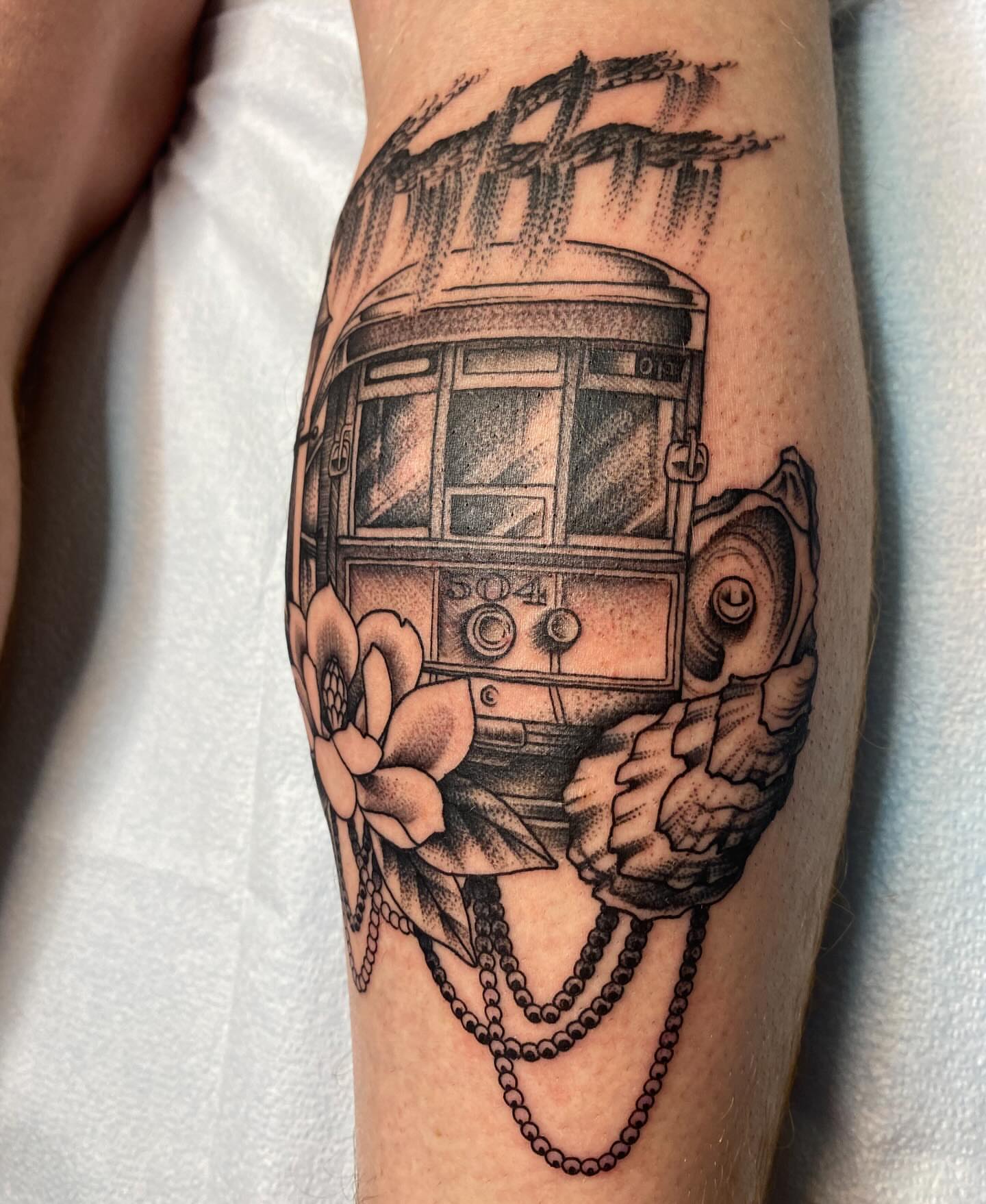 Streetcar and flower black and grey tattoo on the forearm by Vivian HavaTattoo, Richmond, Virginia