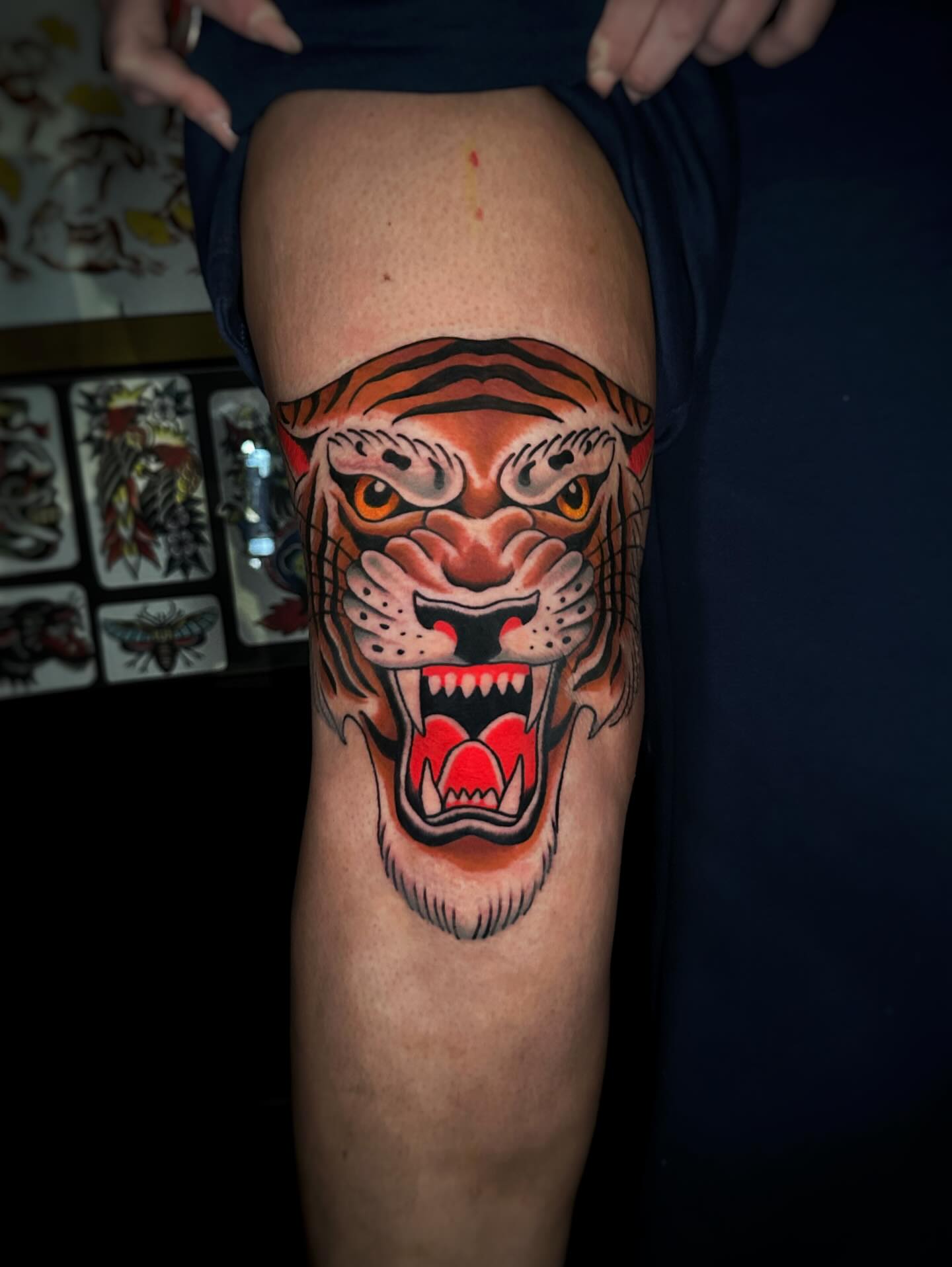 Roaring tiger American traditional tattoo on the thigh by Alex Finnerty, Reading, Massachusetts