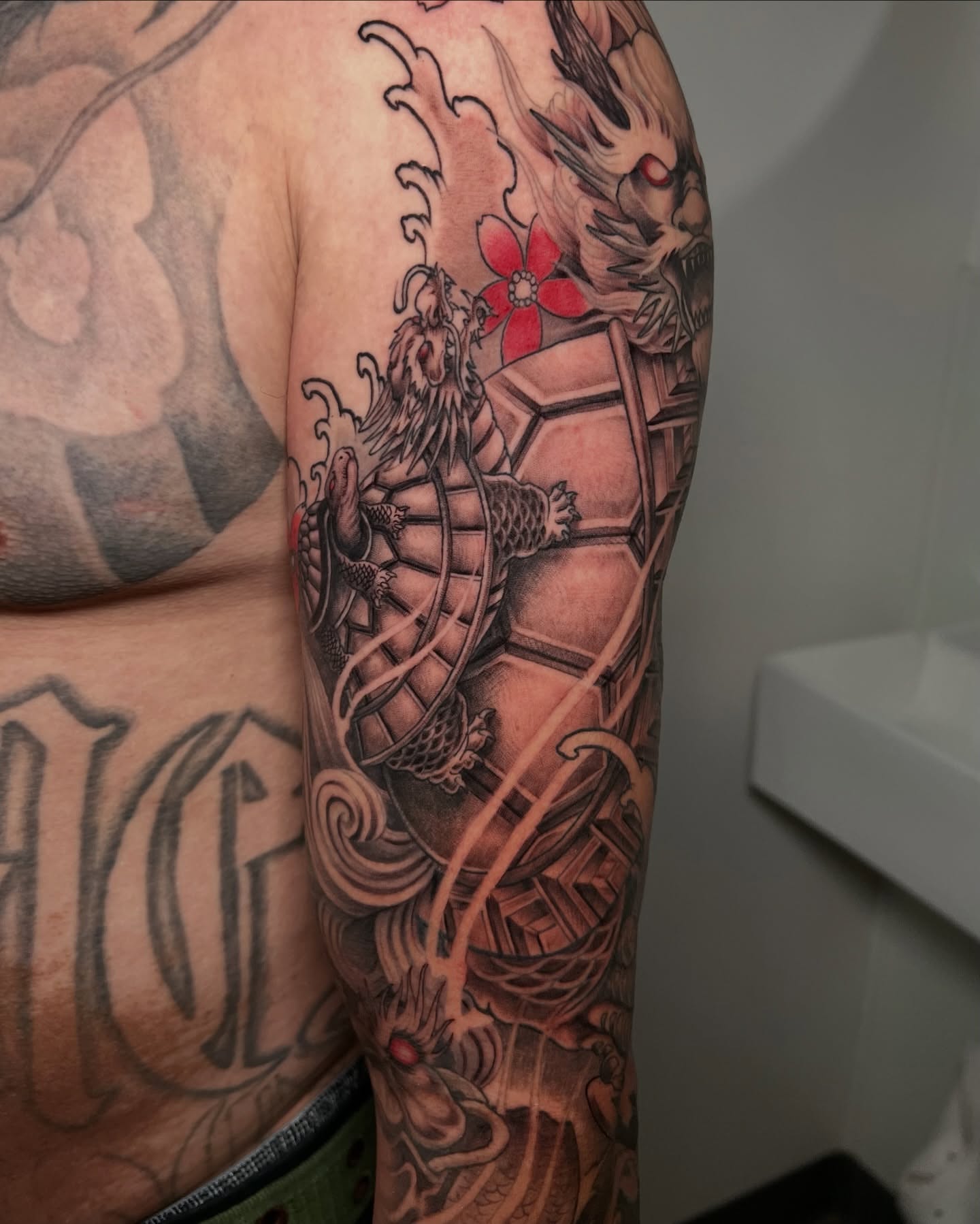 Dragon and flower japanese irezumi tattoo on the forearm by Johnson