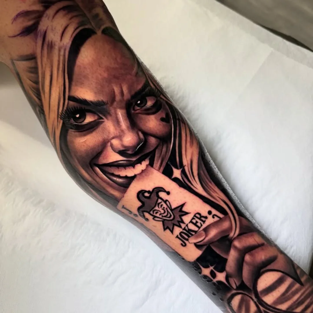 Joker card realism tattoo on the forearm by ink.alchemist