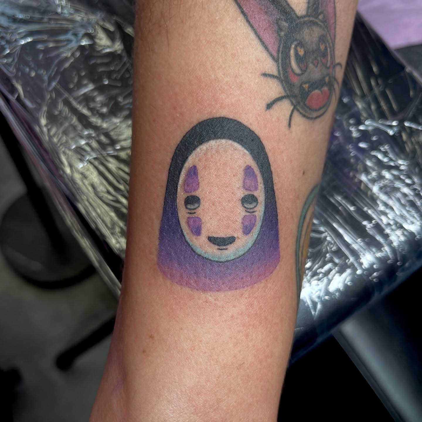 No face anime tattoo on the forearm by Cheyanne Peck