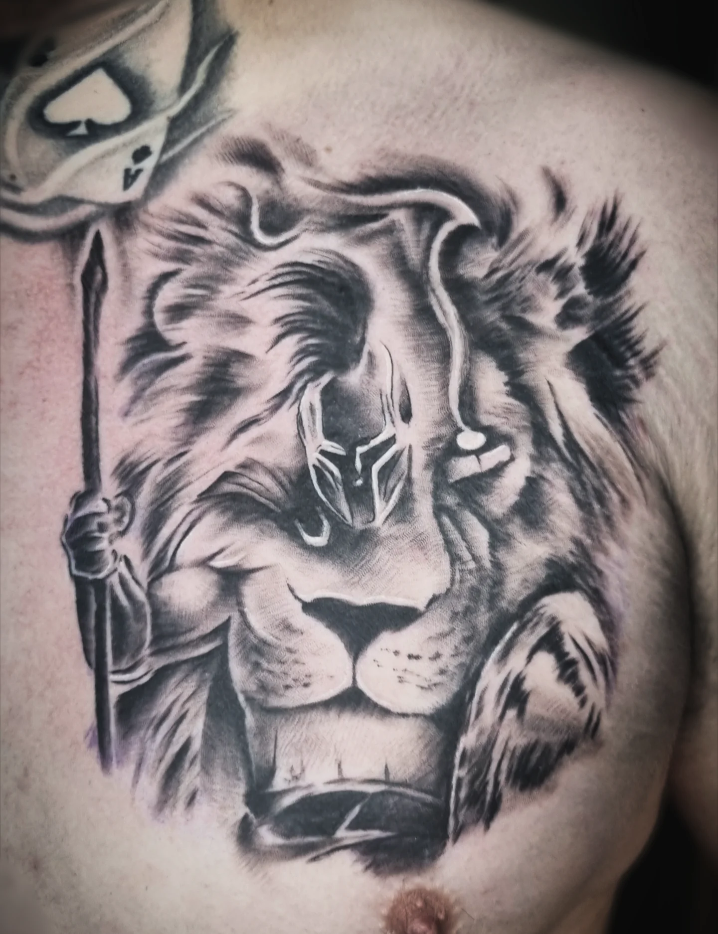 Lion with helmet realism tattoo on the chest by AntiheroTattoo