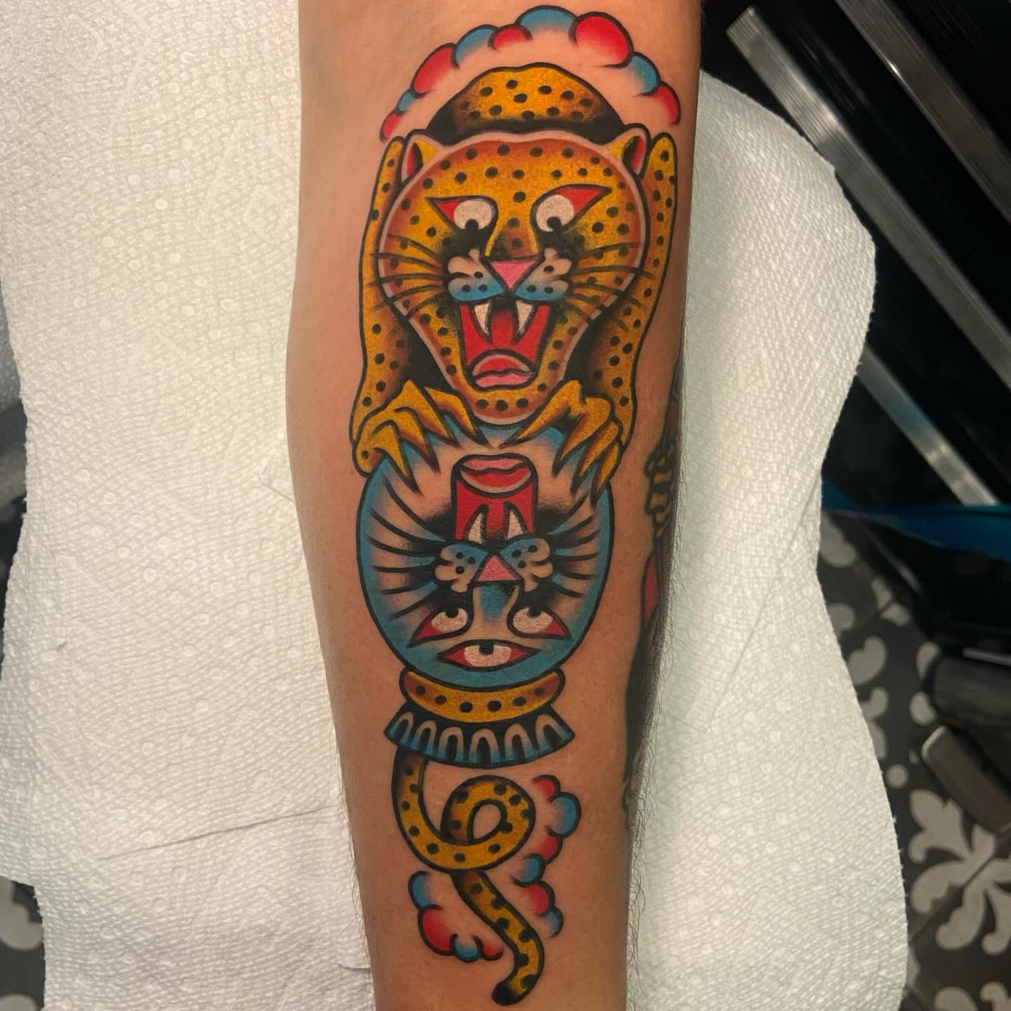 Cheetah and mask American traditional tattoo on the forearm by Anthony Jaeger, Seattle, Washington