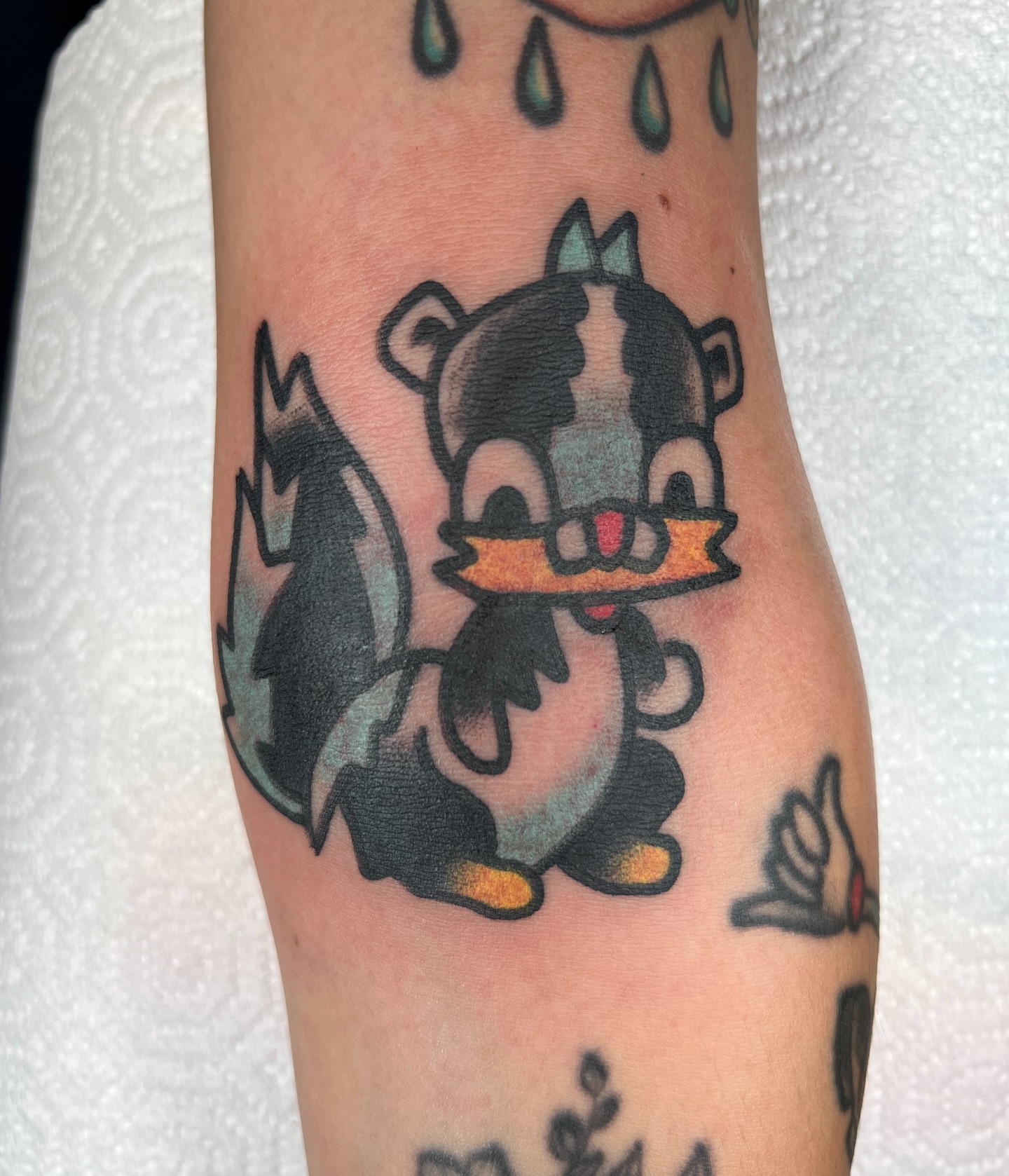 Skunk American traditional tattoo on the forearm by Like A Horse Corral