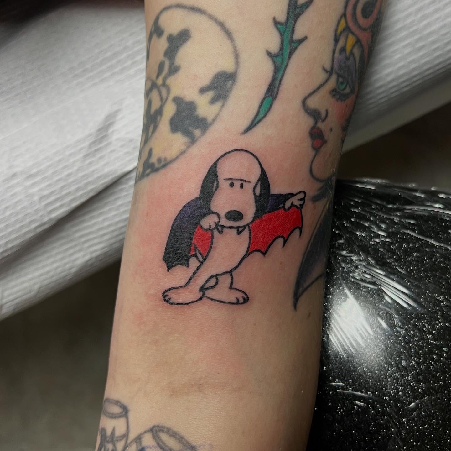 Snoopy bat American traditional tattoo on the forearm by doodle