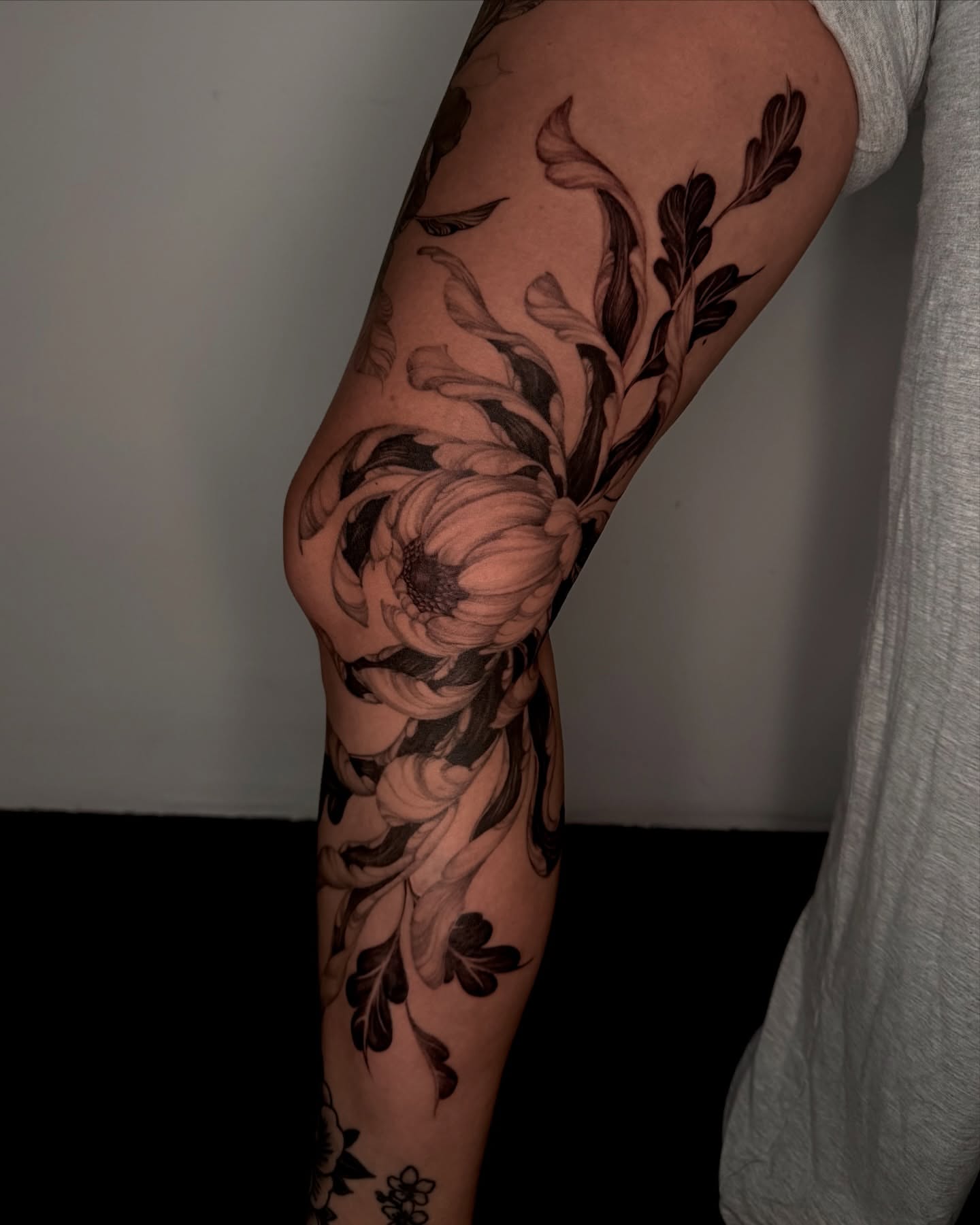 Floral arrangement black and grey tattoo on the forearm by Sab