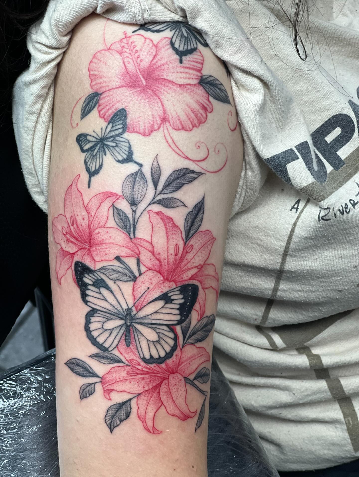 Flowers and butterflies realism tattoo on the forearm by Dany