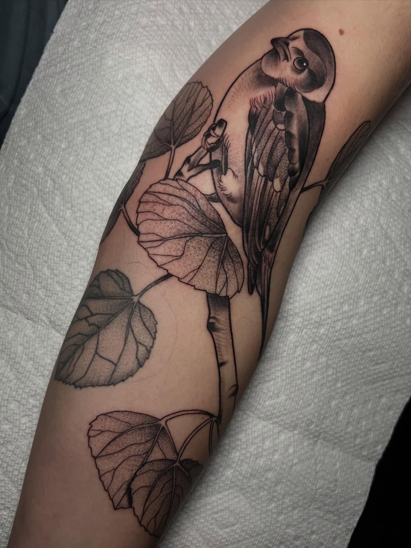 Bird and leaves black and grey tattoo on the forearm by Katie Ann Tattoos