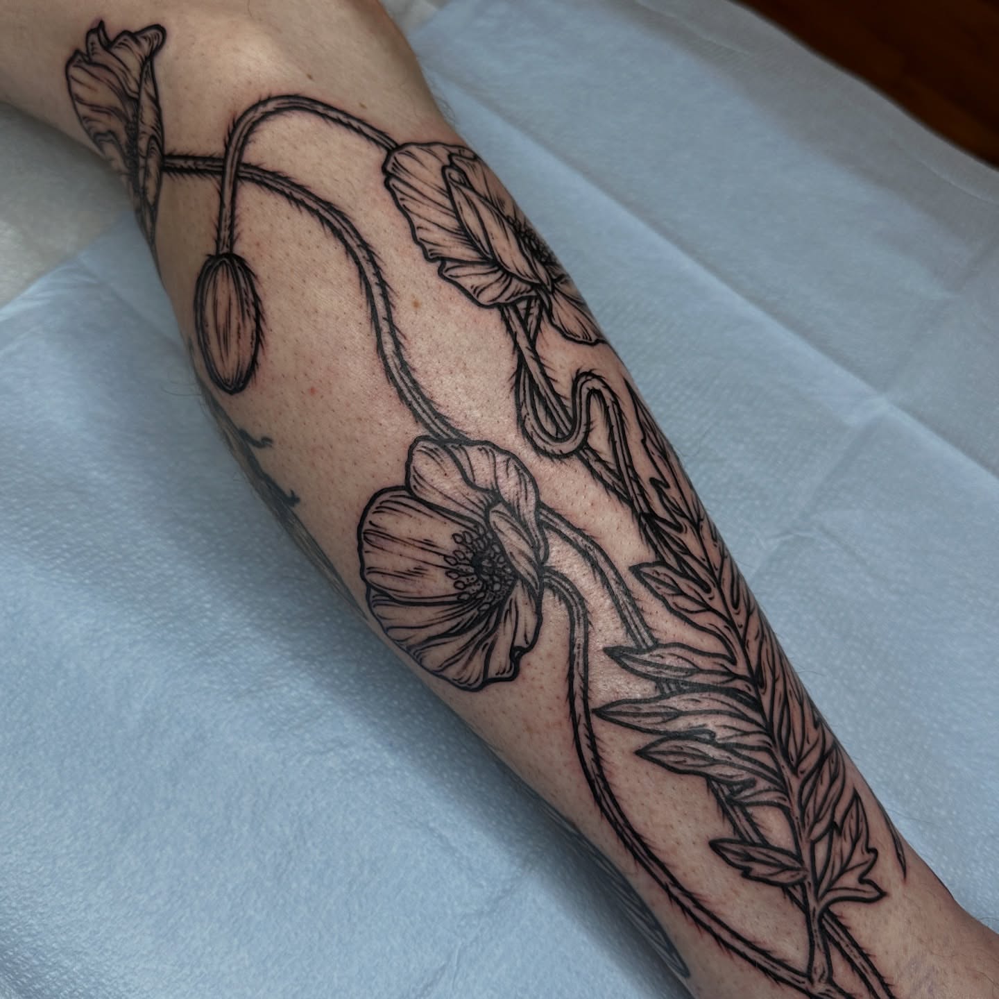 Poppy flowers black and grey tattoo on the forearm by rosalie