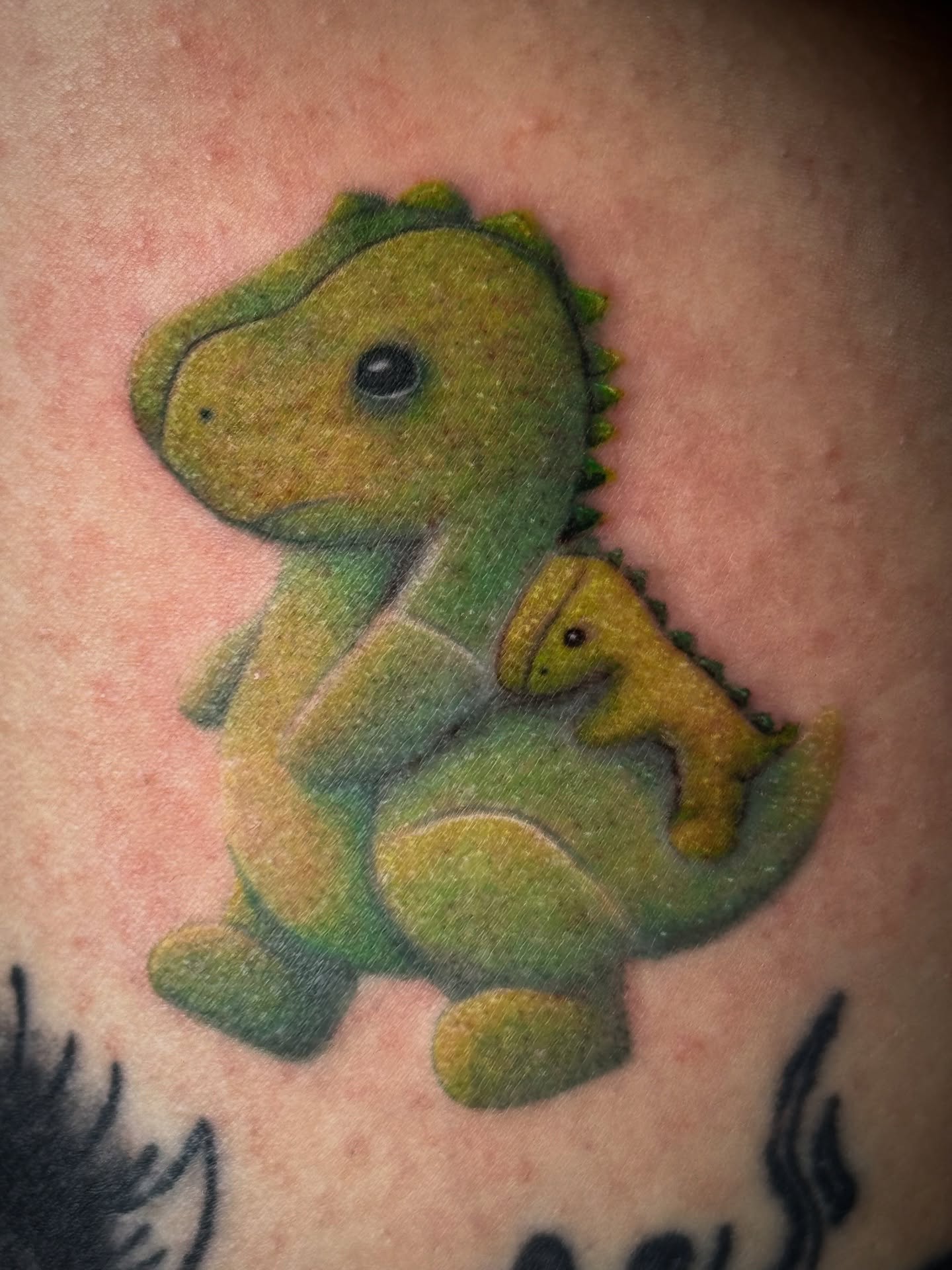 Dinosaur family dotwork tattoo on the back by Gianna G