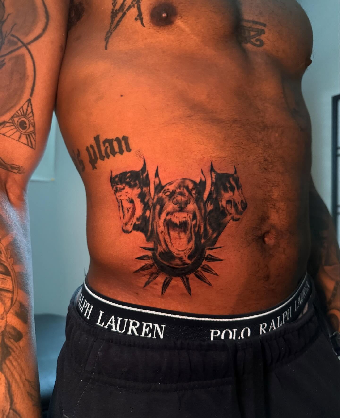 Roaring dogs black and grey tattoo on the torso by sanjai