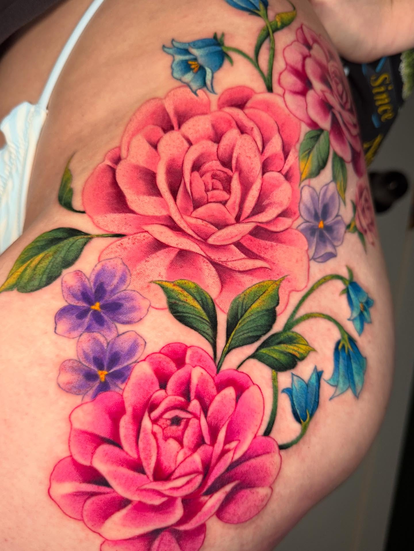 Roses and flowers realism tattoo on the shoulder by Skye Kimball
